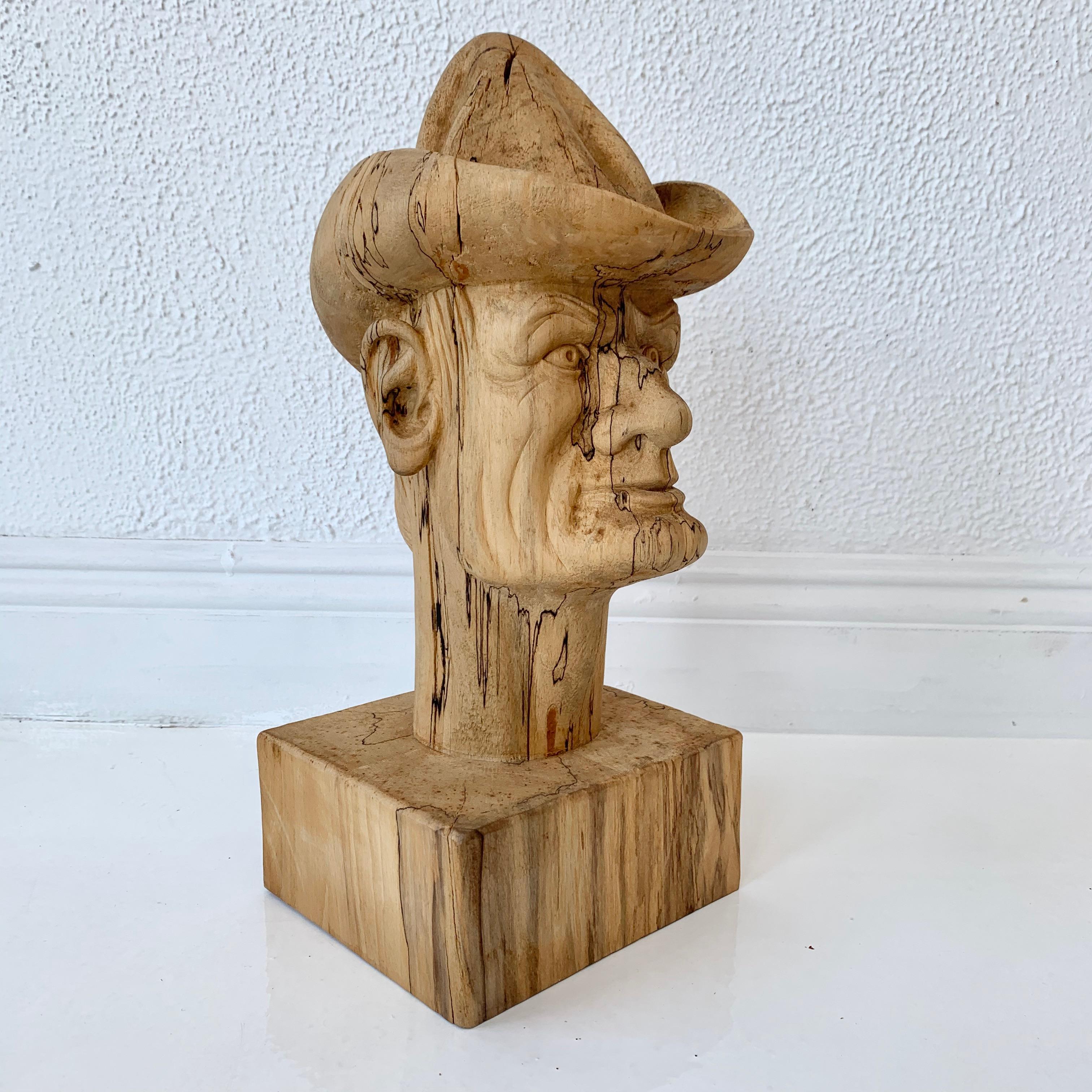 Hand carved wood cowboy bust. Excellent workmanship and detail. An ominous face. Slightly scary appearance. Very well done. Signed N Weisman.
