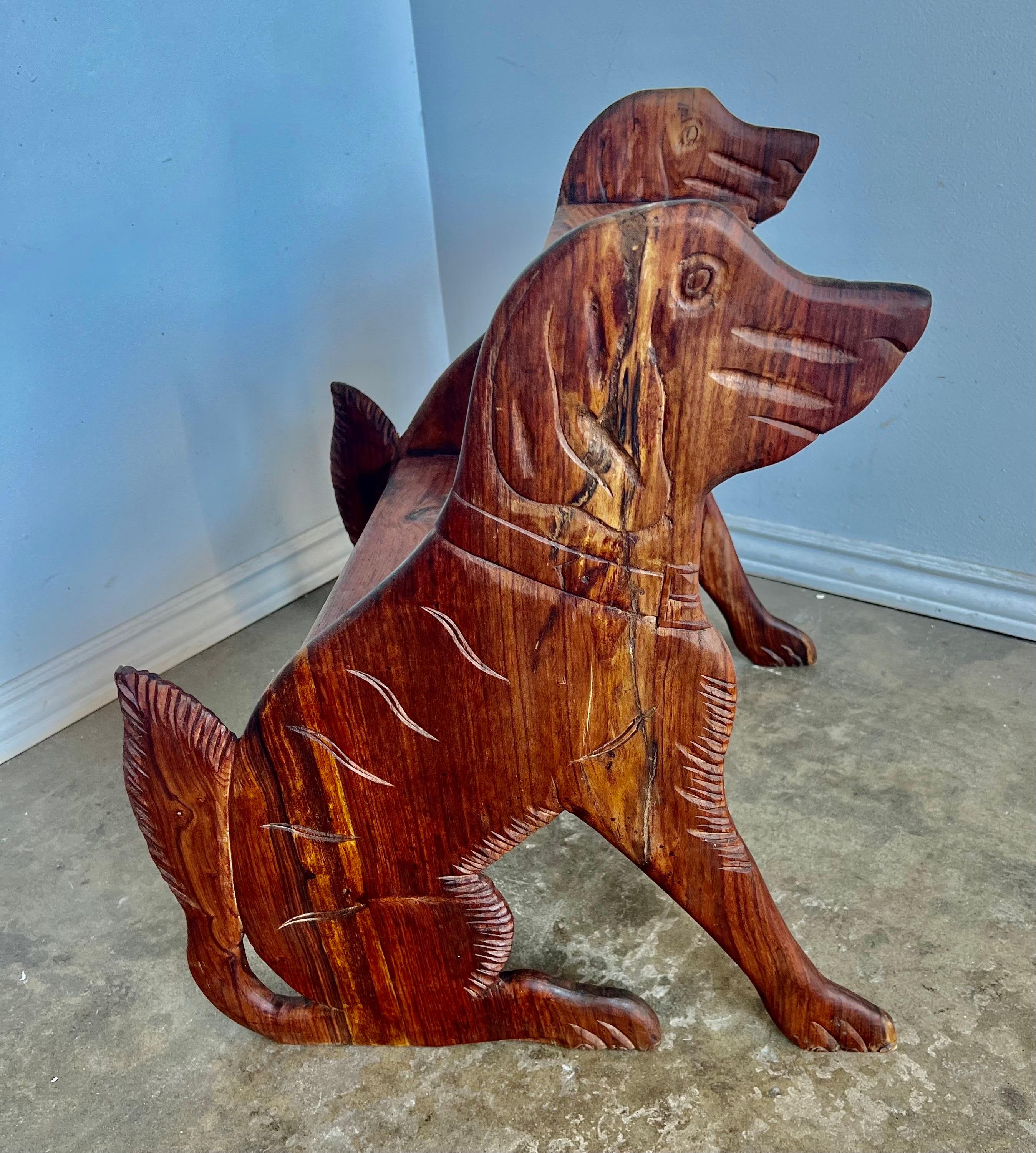 Charming mid-20th century hand carved step stool with carvings of dogs on both sides.  The charming piece of folk art would add the perfect touch for that small library or office.