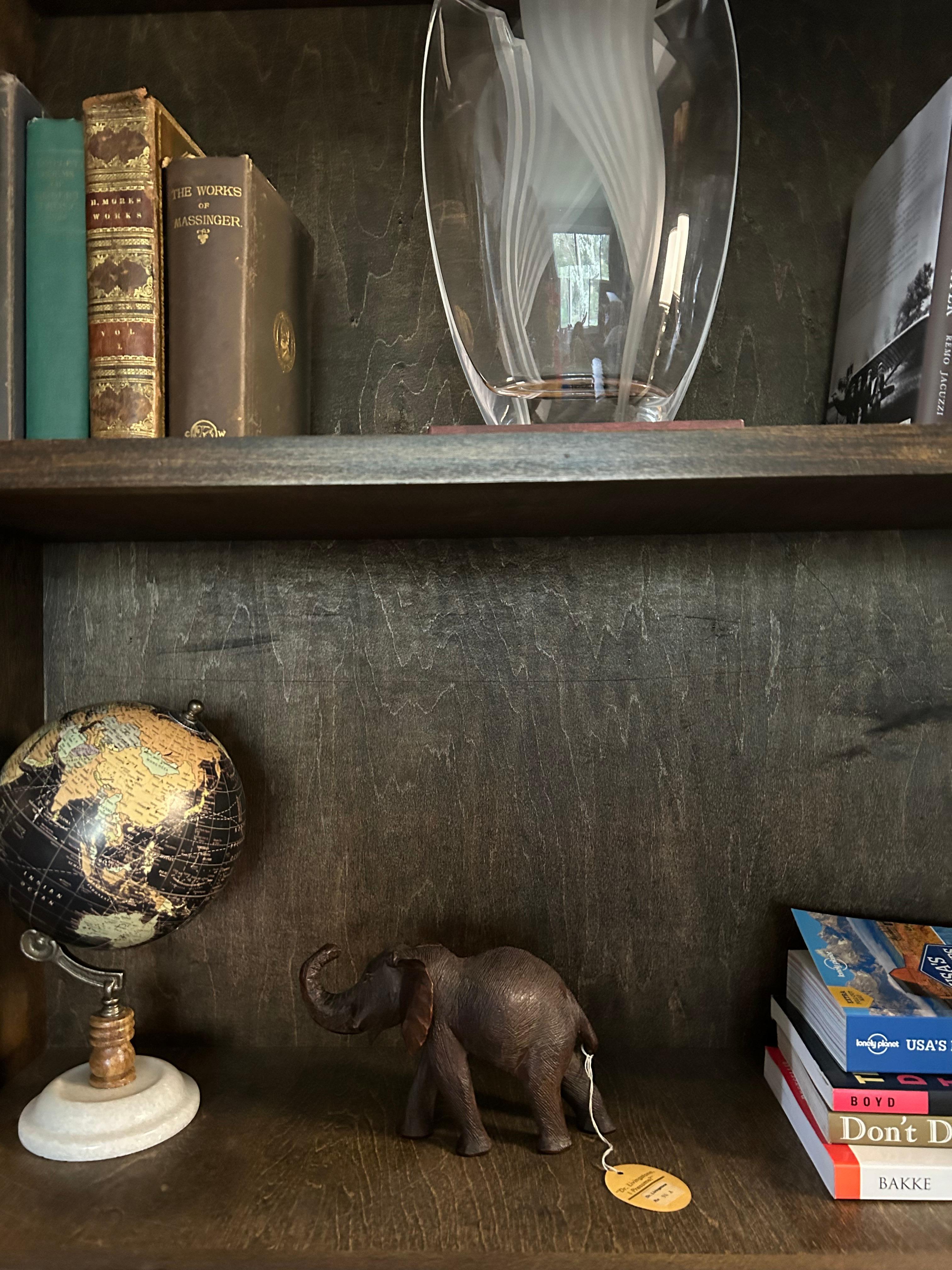 Unique hand carved Elephant sculpture by Dr. Livingstone Collection. It is in great condition and includes the tag of the collection name. This perfect to add to your home library, desk, or a bookshelf in your home. 
