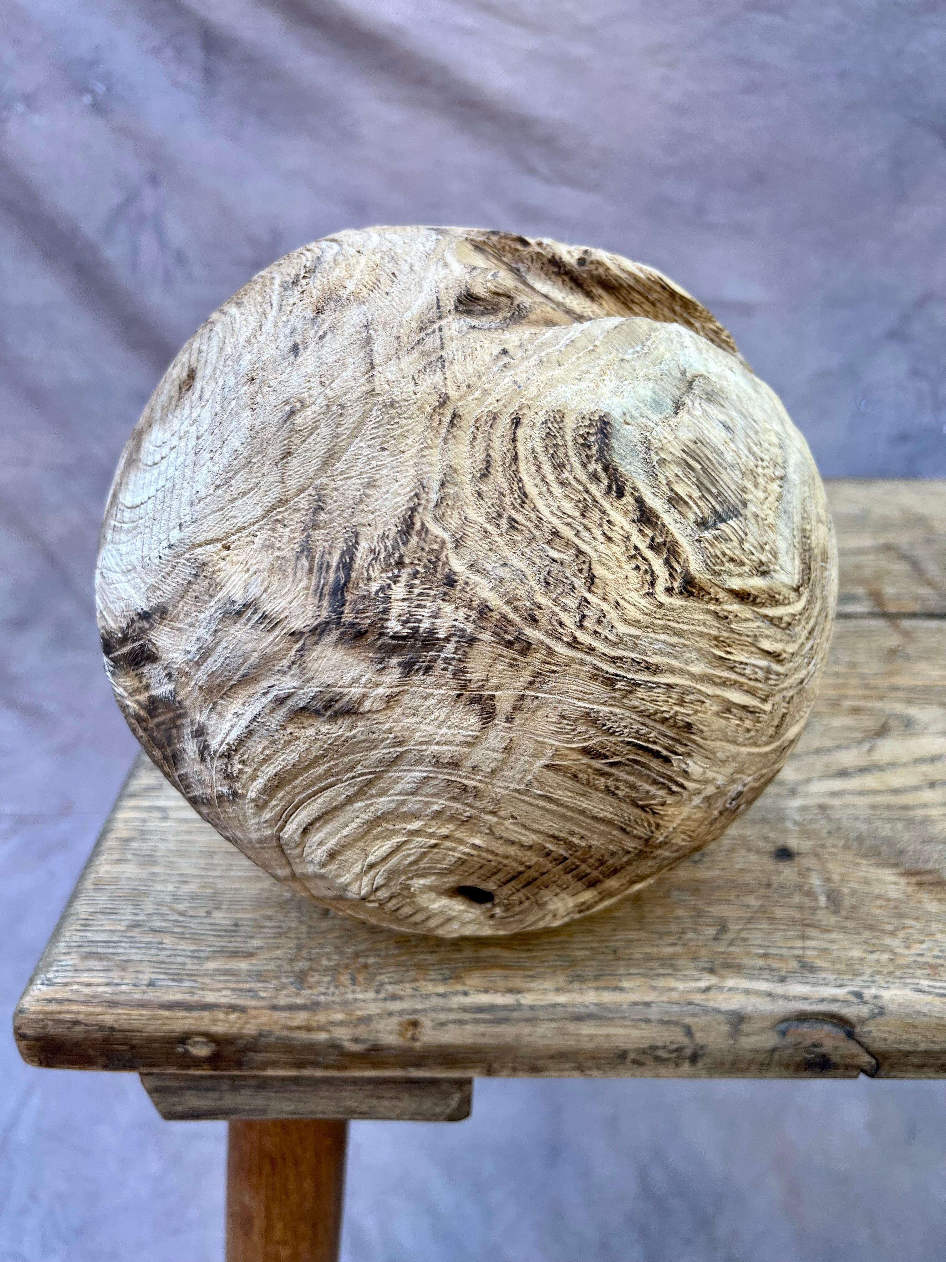 Unique hand-carved folk art-style wood gazing ball. A friend of bookshelves and coffee tables. A lovely garden accent. An organic doorstop. 

A compliment to any room-- great support in pondering life's big questions. Gaze into the unique wood