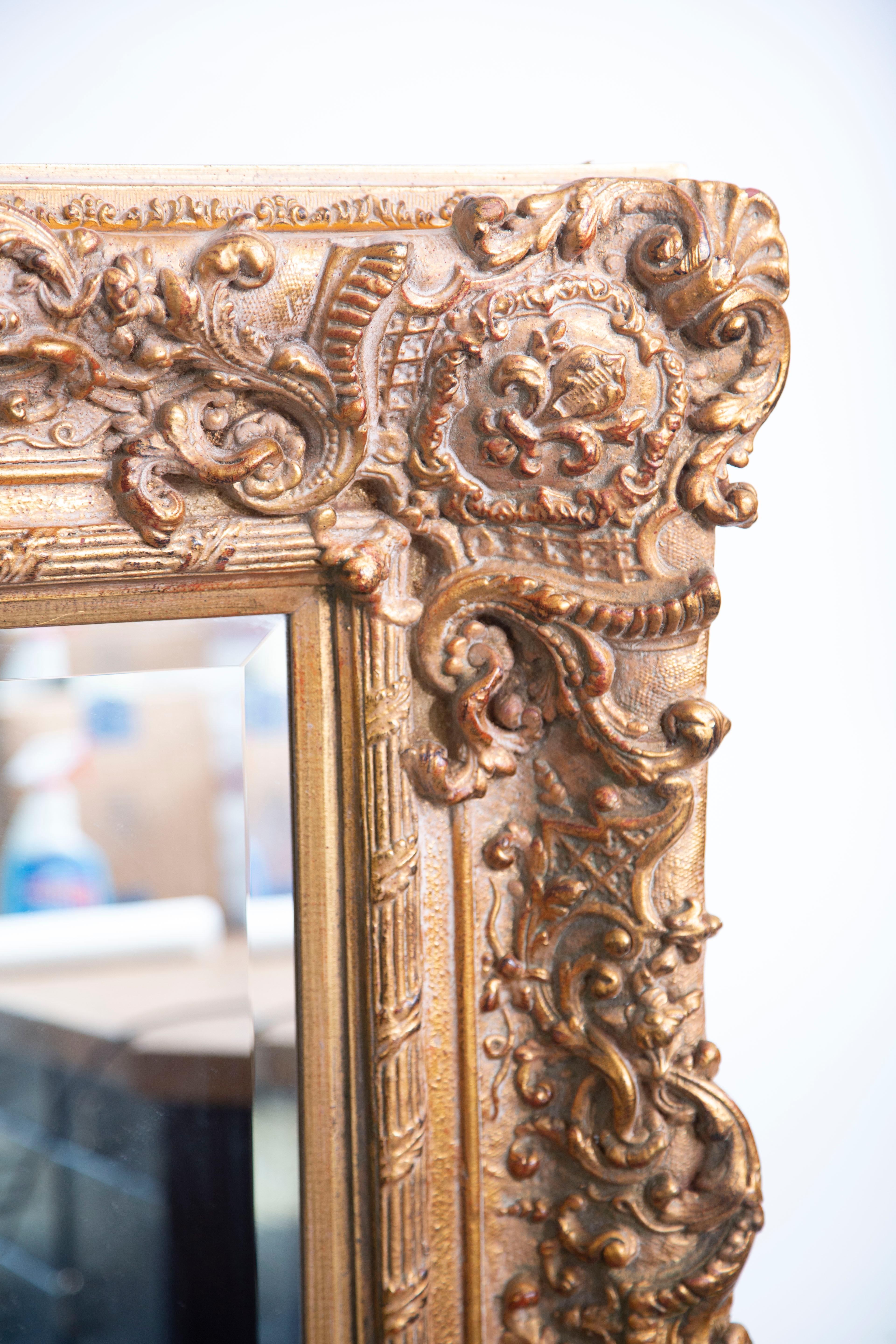 Gorgeous monumental hand carved wooden mirror made of wood, gesso and gilt.