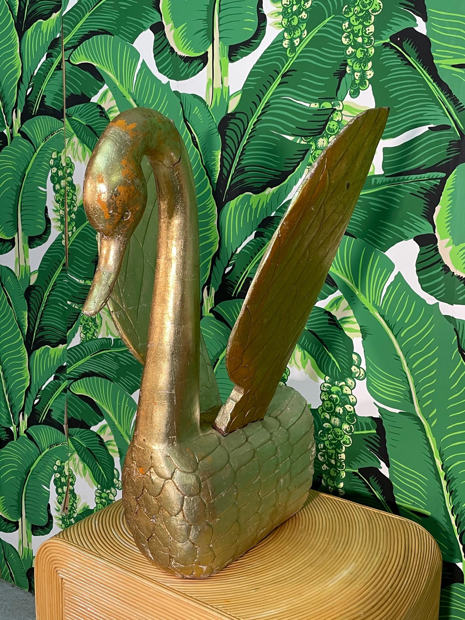 Large hand carved solid wood swan figurine with full gold leaf veneer. Intricate design and lovely patina. Good condition with imperfections consistent with age (see photos).
 