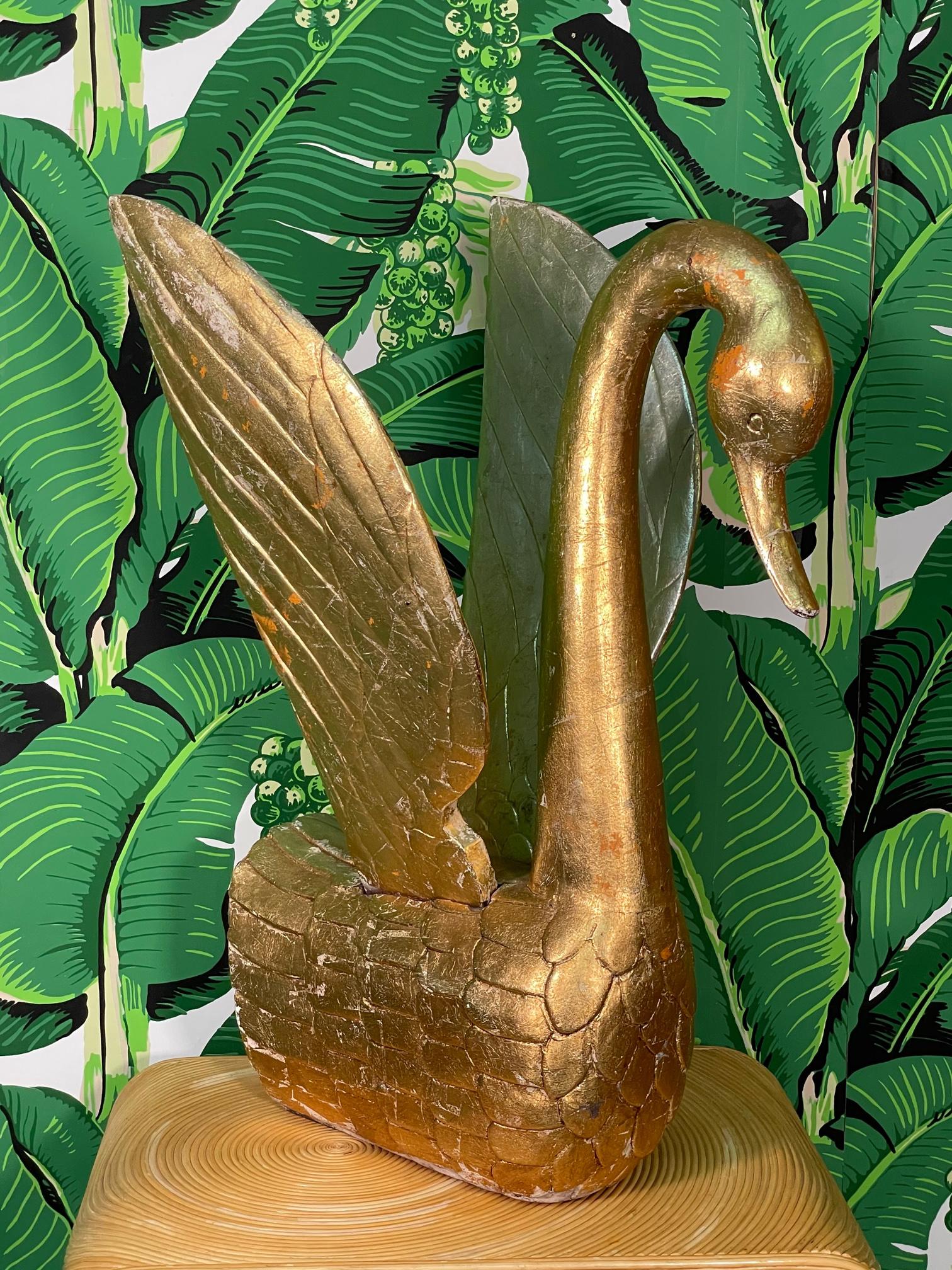 Large hand carved solid wood swan figurine with full gold leaf veneer. Intricate design and lovely patina. Good condition with imperfections consistent with age. May exhibit scuffs, marks, or wear, see photos for details. 
 
 