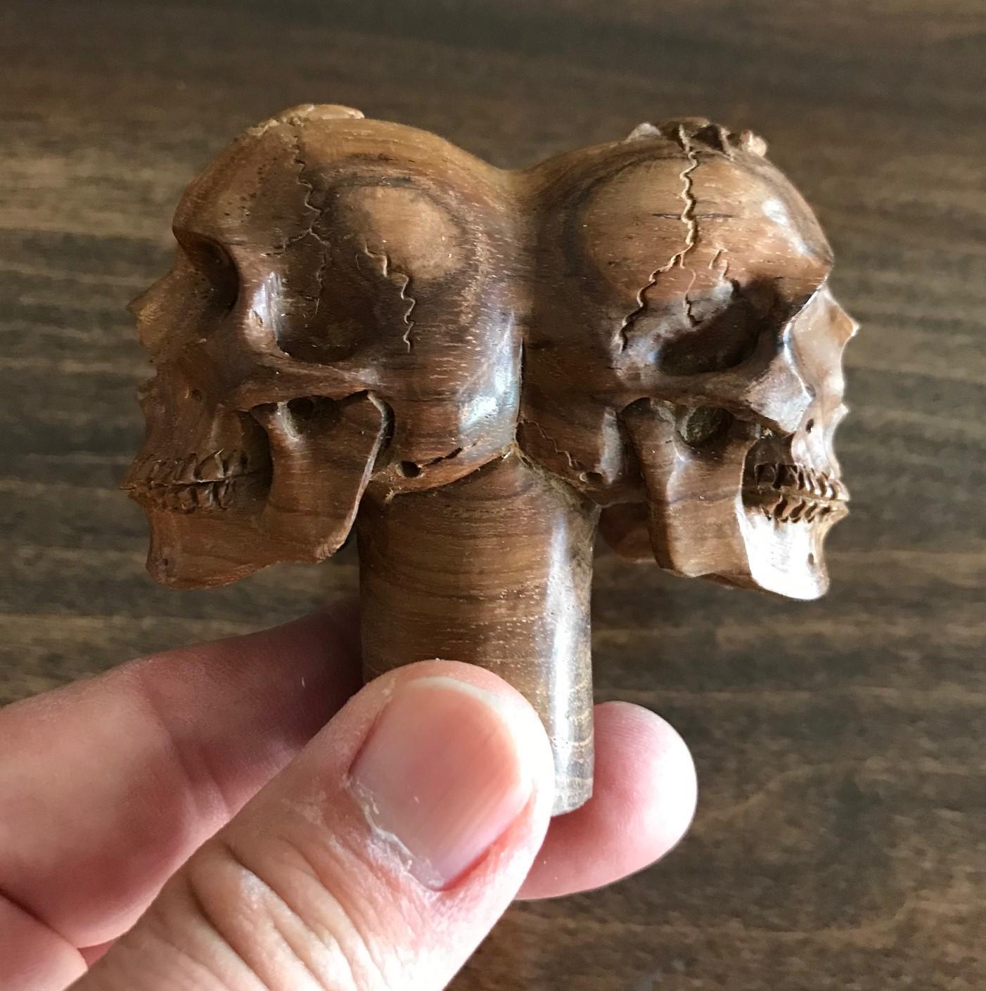 A fantastic and wonderfully hand carved piece. These smiling, mischievous skulls are hand carved in very Fine detail. Would be the crown jewel of any walking stick collection once attached to the cane. Truly a unique and one of a kind