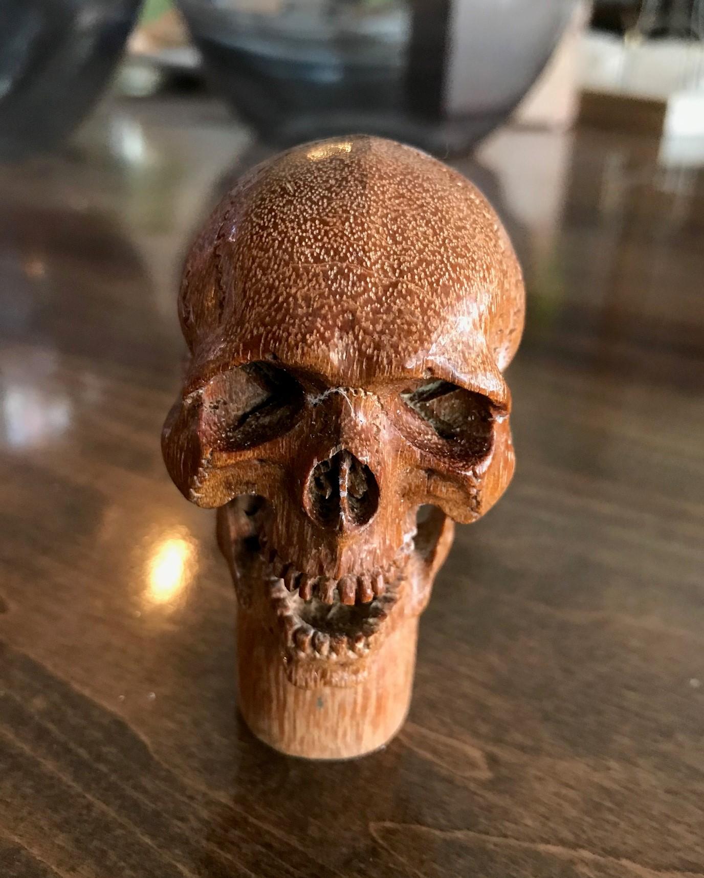 A fantastic and wonderfully hand carved piece. This smiling, mischievous skull is carved in very fine detail. Would be the crown jewel of any walking stick collection once attached to the cane. Truly a unique and one of a kind work.

Dimensions: