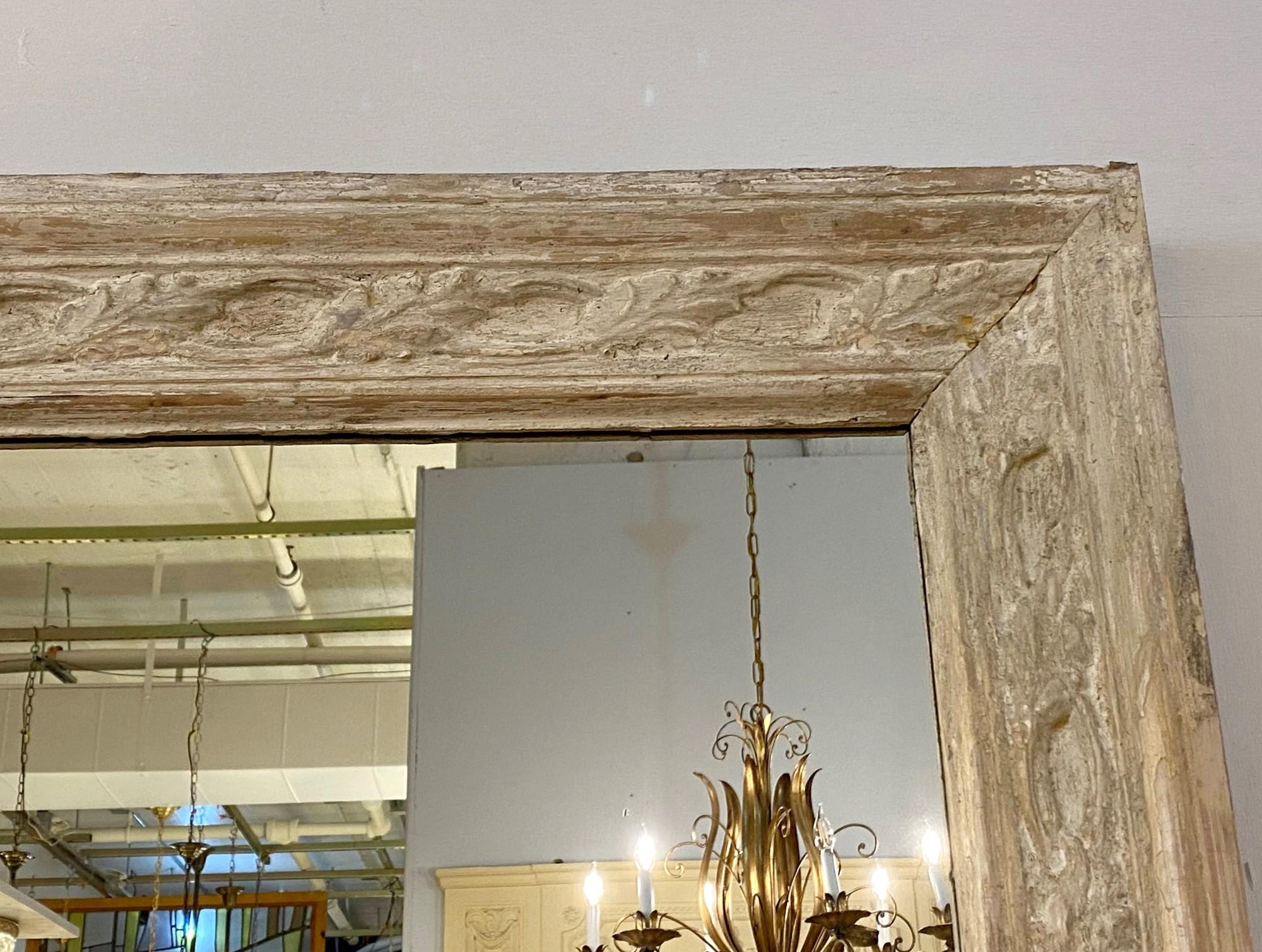1880s antique hand carved wood door molding with original paint reclaimed from an old Brooklyn brownstone now newly made into a wall mirror. This can be seen at our 333 West 52nd St location in the Theater District West of Manhattan.