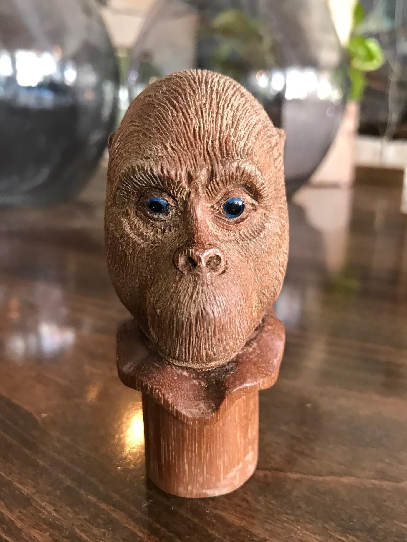 A fantastic and wonderfully hand carved piece. This mischievous looking monkey has beautiful blue glass inset eyes. Would be the crown jewel of any walking cane collection once attached to the cane. Truly a unique and one of a kind work.