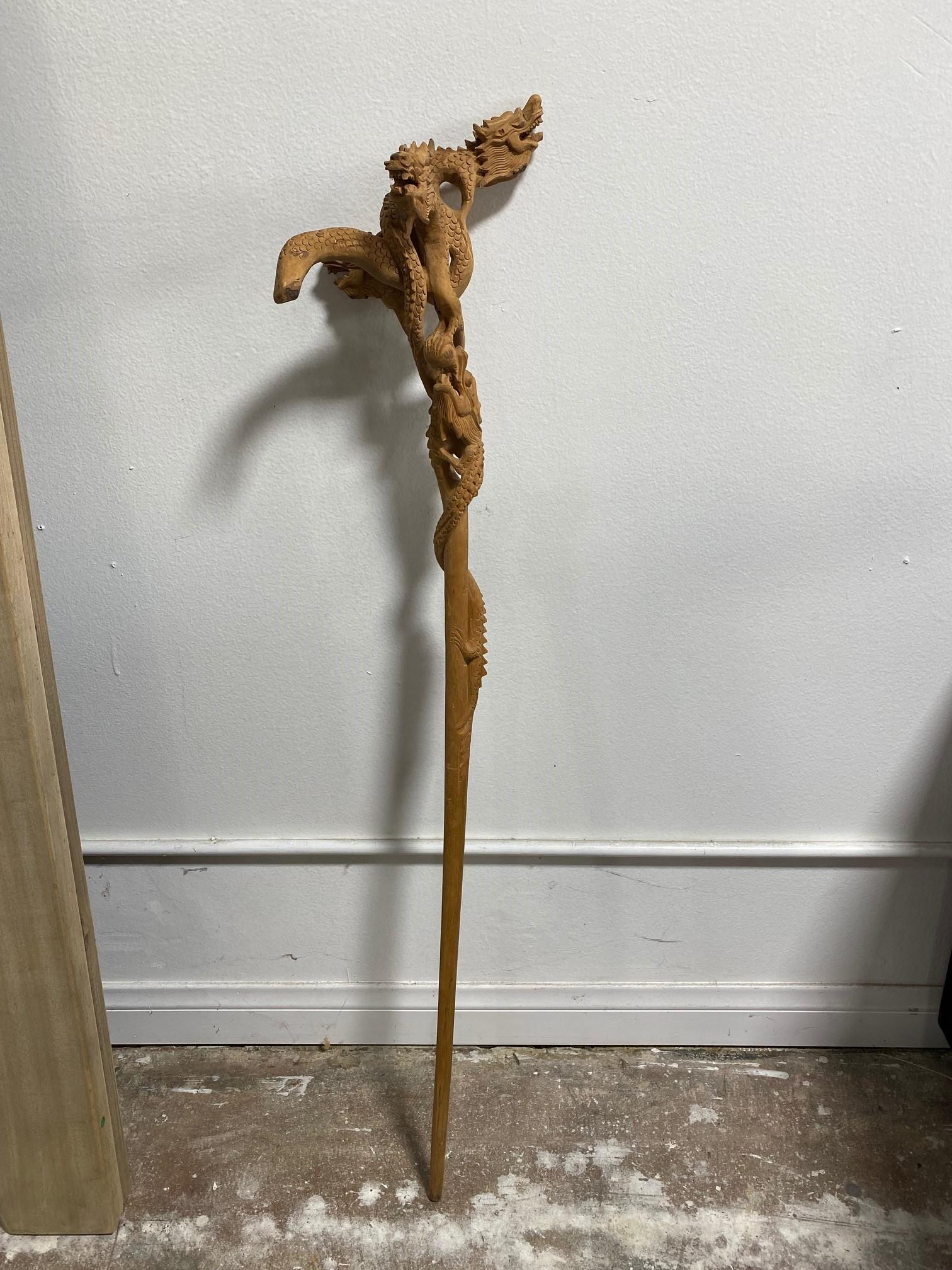 A rather fantastic and unusual walking stick/ cane. Hand carved from wood. Multi dragon heads. We have not seen another quite like it. 

Has a great feel and clearly unique look. 

A unique piece to add to your collection.

Dimensions: 44