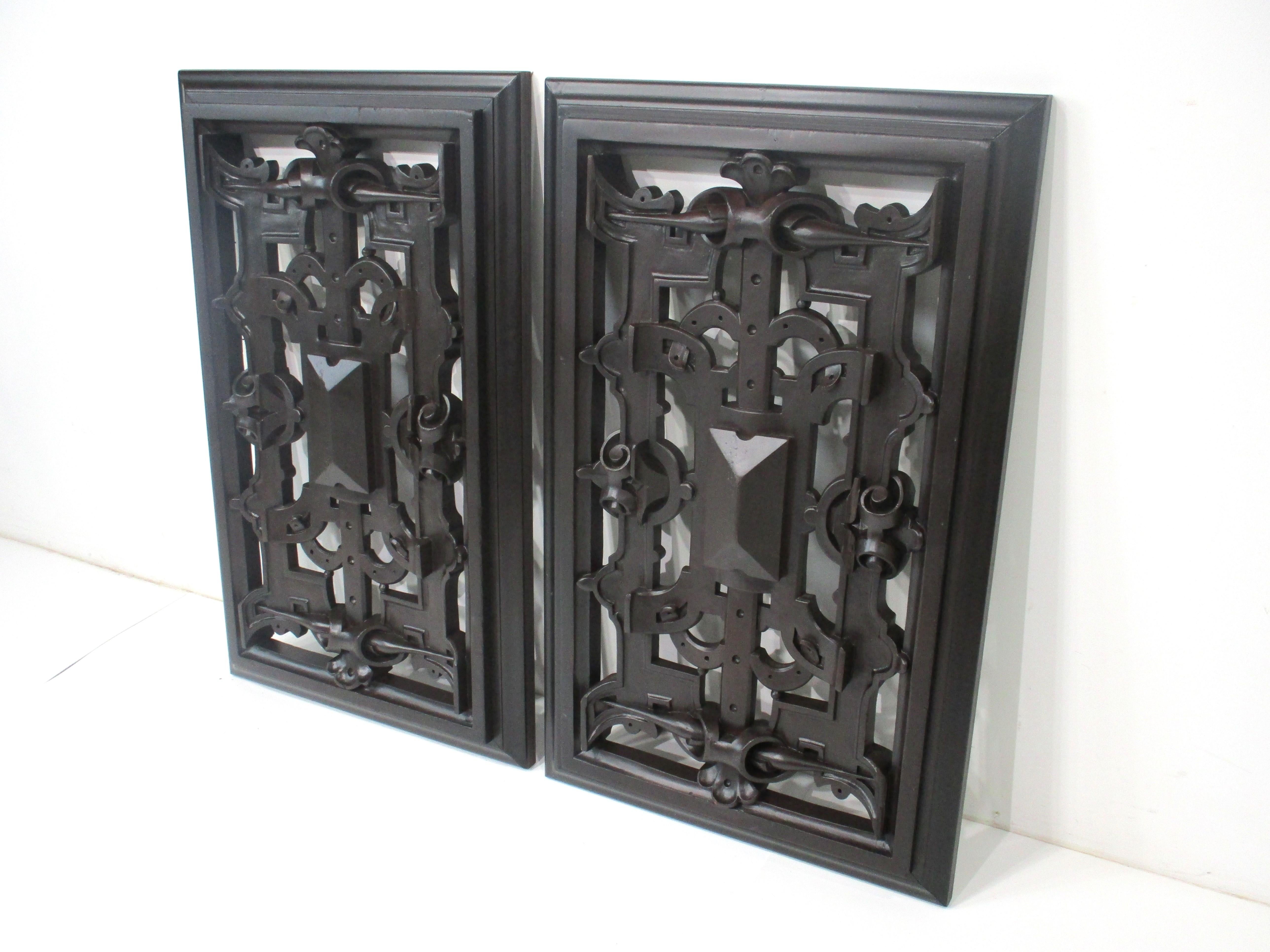 A pair of hand carved wood panels with intertwining designs covering the whole front and back with a framed look to each . Two well crafted pieces that could be used hanging in front of small windows since there is space between the carvings for