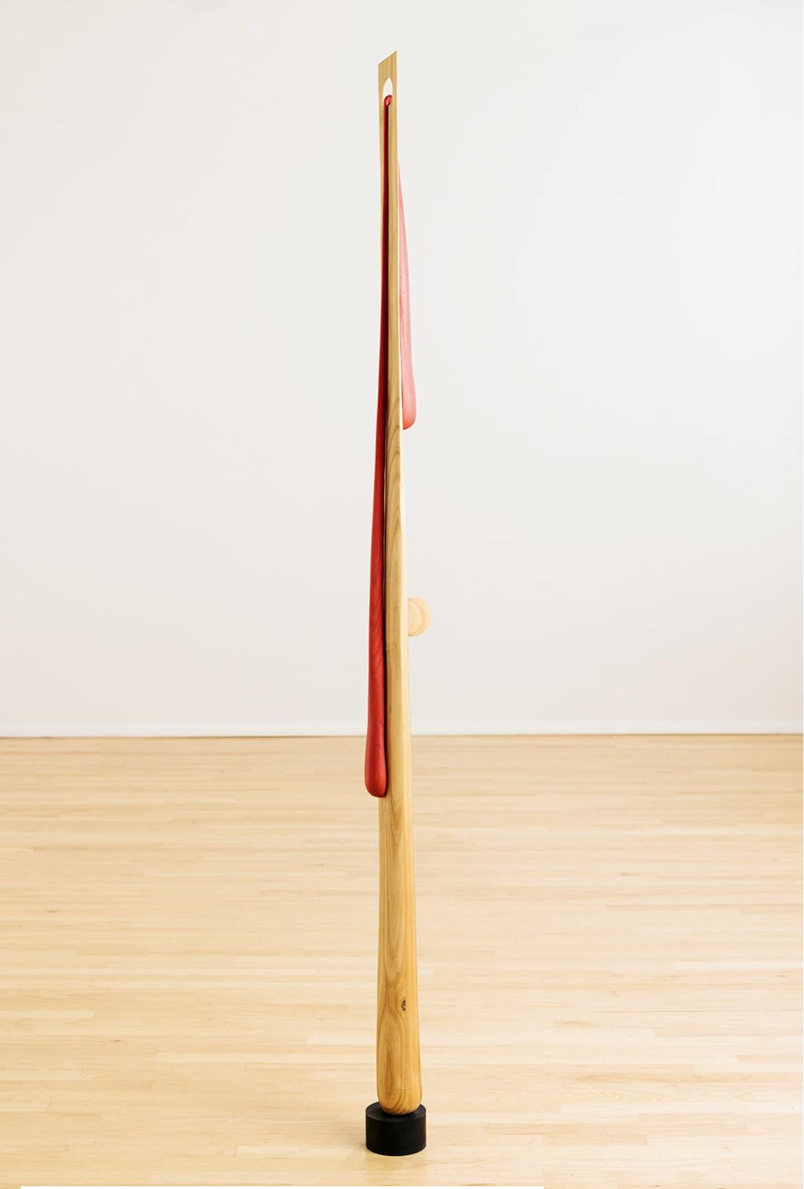 This hand-carved poplar sculpture delicately tapers from bottom to top. From the top, a red-dyed tear drop falls over both sides. Steve Turner slowly works the wood, revealing natural elements, rings and knots present in the wood. This modern totem