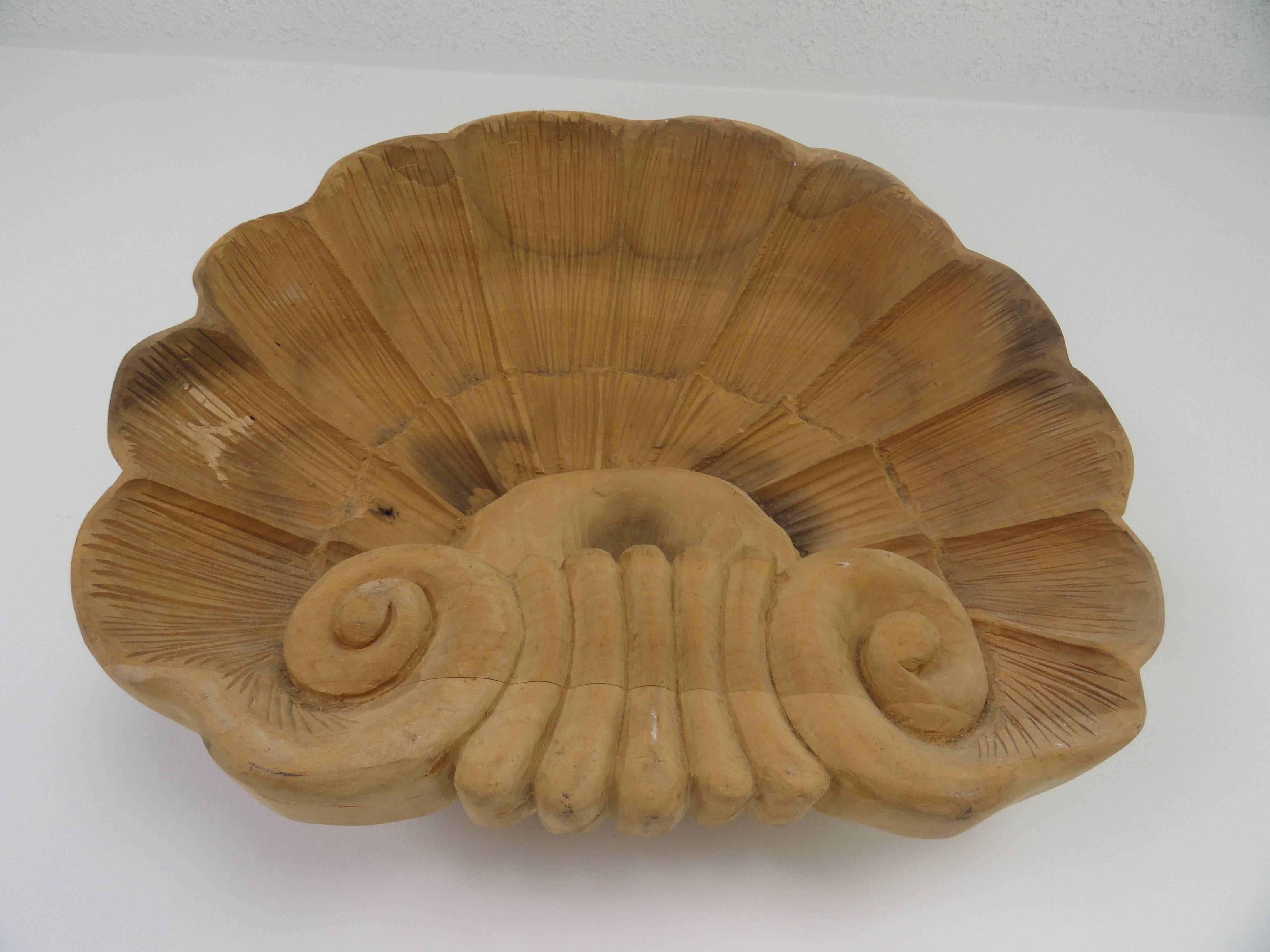 Hand-carved wood shell sculpture.