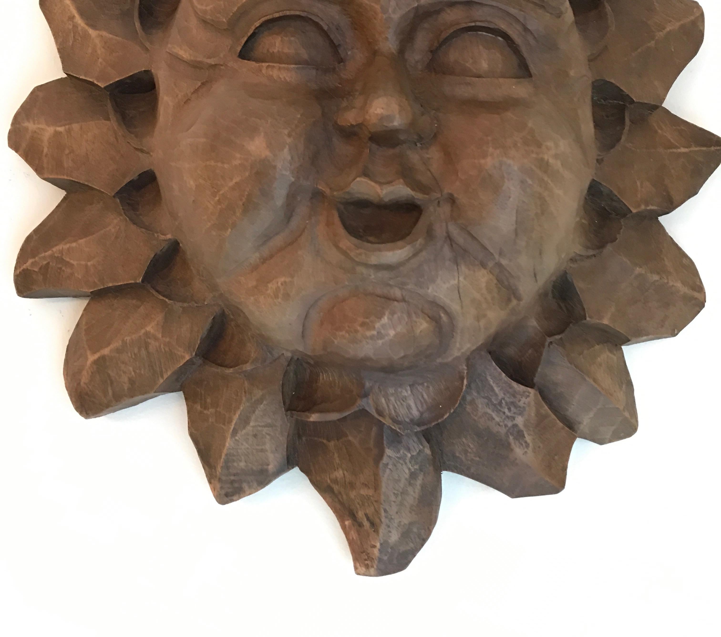 Hand carved wood sun face wall plaque.