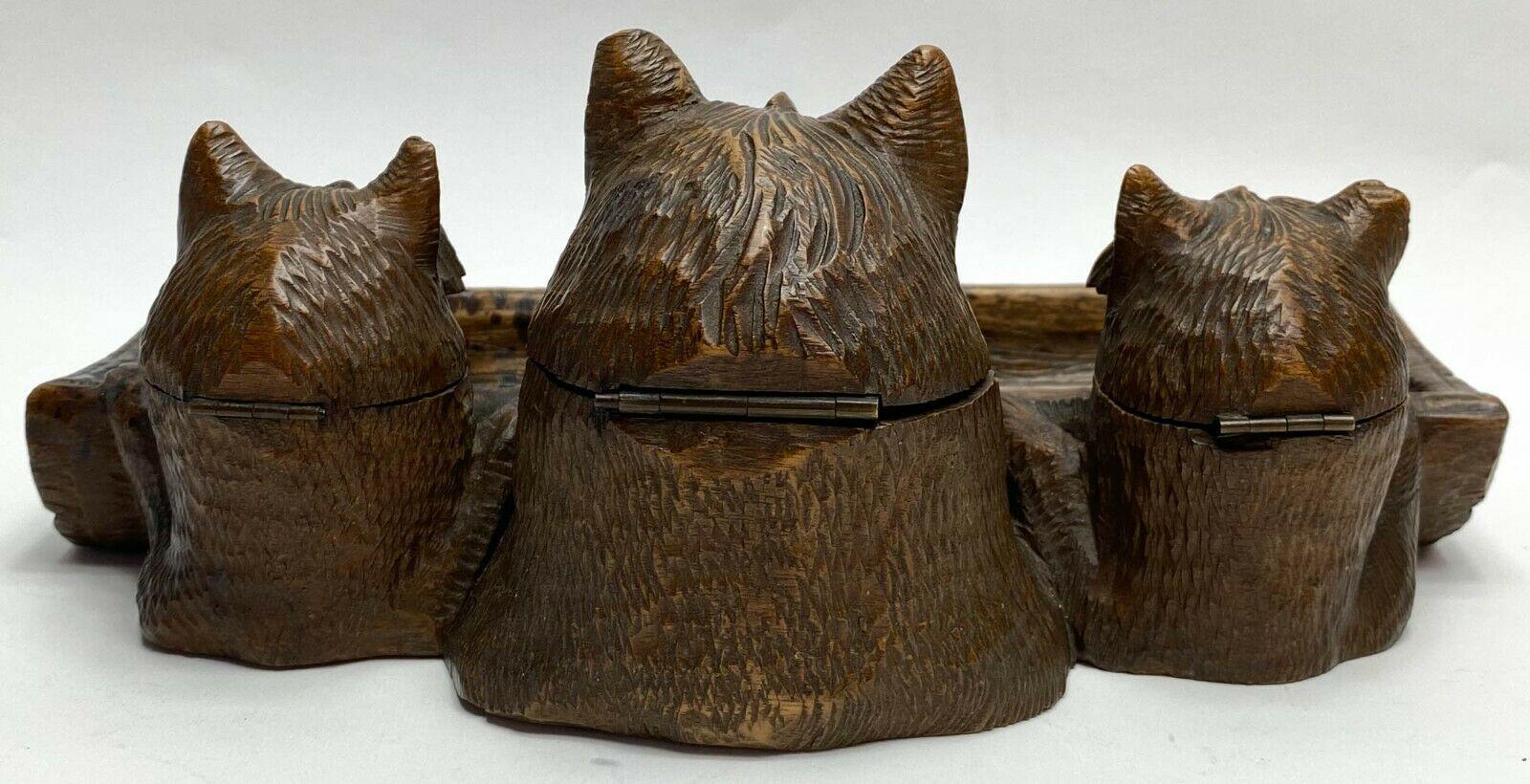 Hand carved wood terrier dog pen tray ink well ink stand Early 20th century

Hand carved figural dog, possibly terrier breed, ink stand with modeled two ink holders and one nib holder. Probably American or German.

Additional