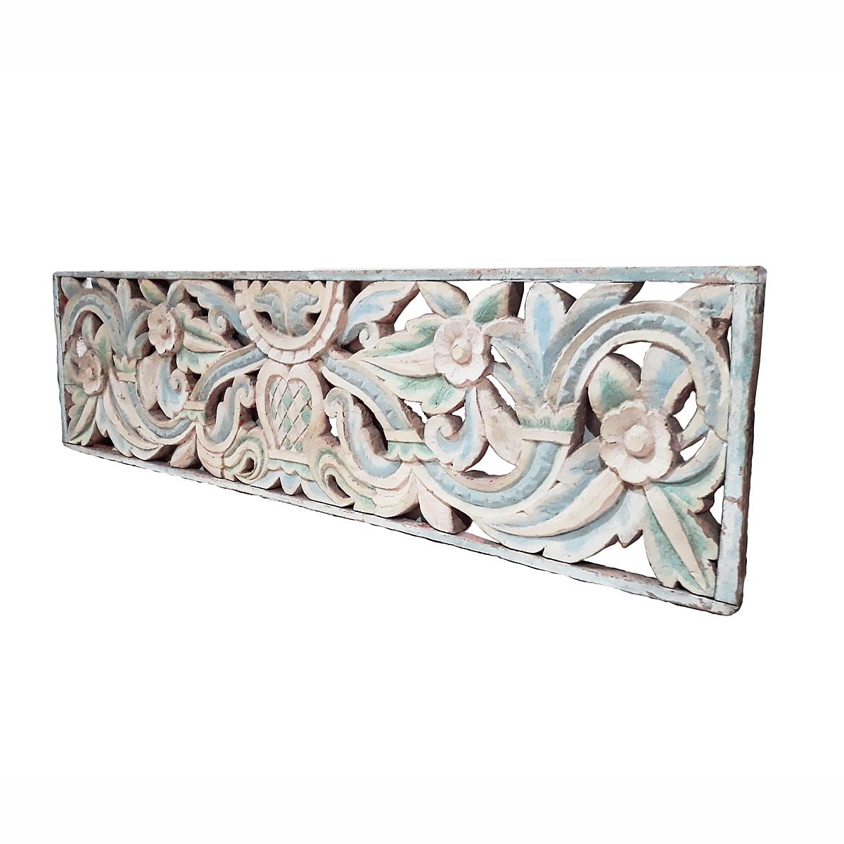 An early 20th century teak wood panel from Indonesia, intricately hand carved and polychromed in white and light blue. Floral motif, circa 1900.