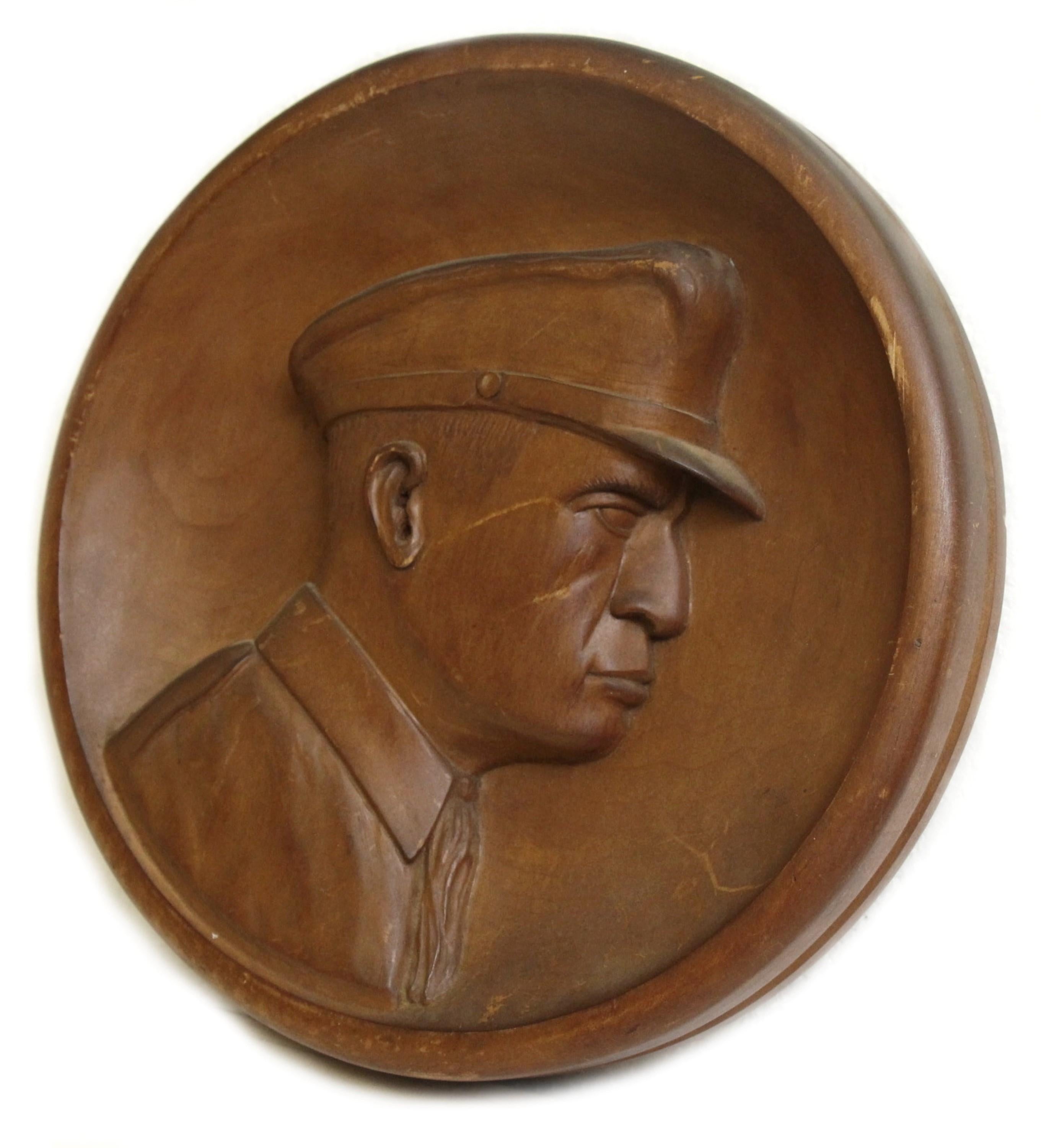 Mid-20th Century hand carved wood plaque of General MacArthur. Signed A.B. Deleourey 1856-1944 Boston, MA. Minor scratches. This can be seen at our 400 Gilligan St location in Scranton, PA.