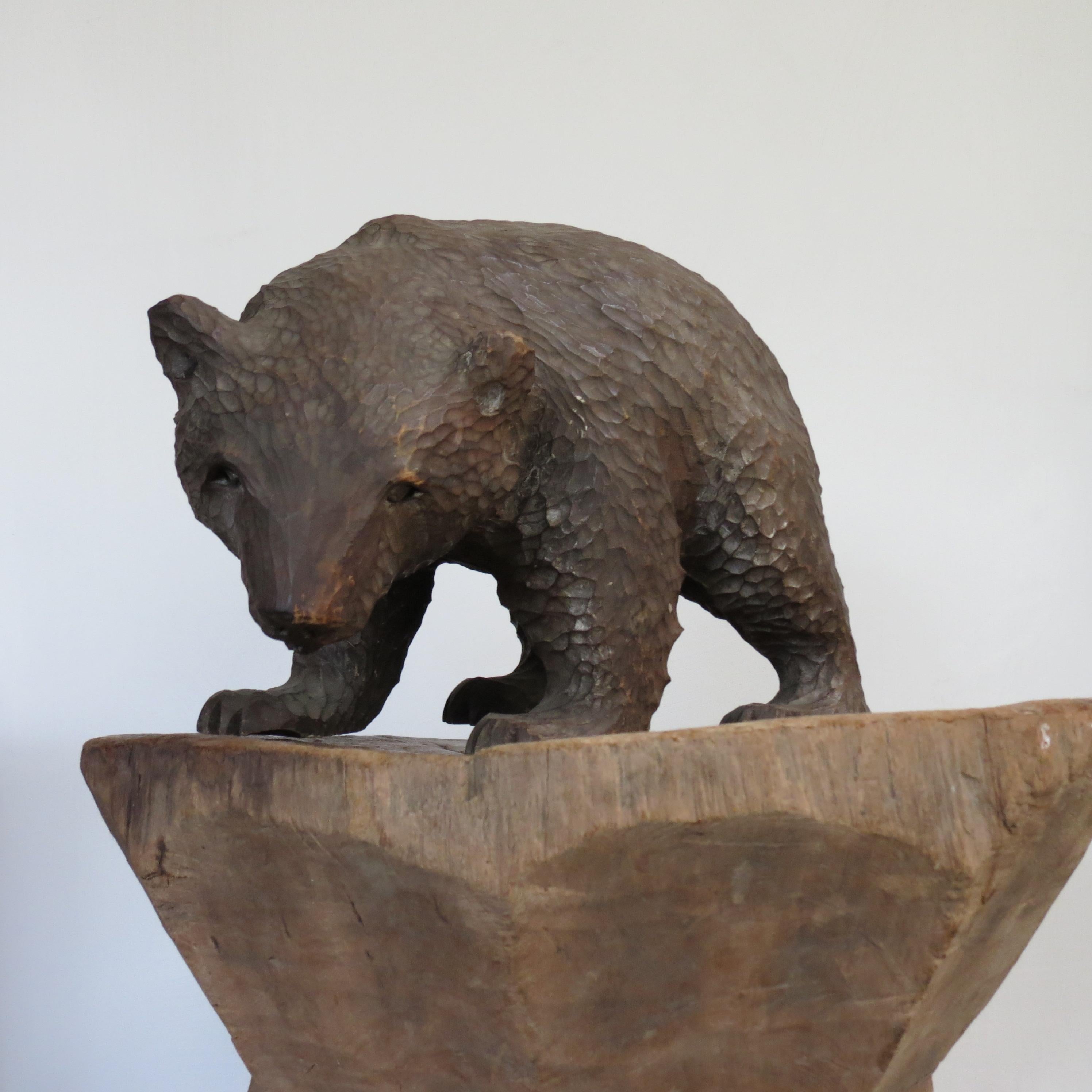 A wonderful carved wooden bear from the Hokkaido region.  Hand carved by the Ainu people, exceptional, good quality carving. This bear has a wonderful realism to it, the bear looks as though he is turning to walk away.  He demeanour is almost demur,