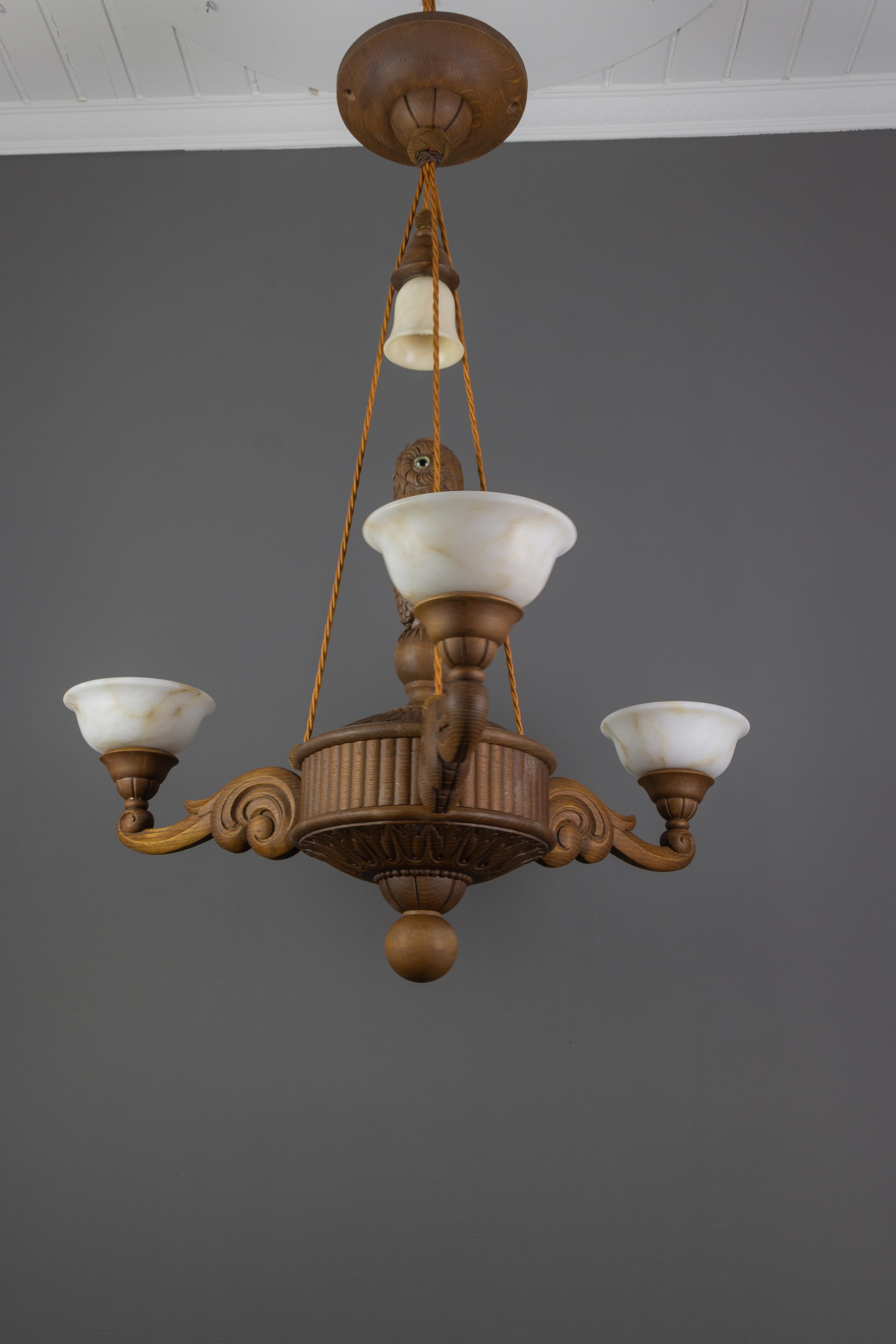 Mid-20th Century Hand Carved Wooden and Alabaster Four-Light Chandelier with Owl Figure, Germany