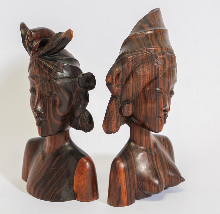 Vintage midcentury hand carved ebony wooden Balinese bookends.
Hand carved sculpture in wood depicting a Balinese couple.
Bust of a man and women in Art Deco style sculpture wearing traditional head dress, great details.
Handcrafted in Bali,