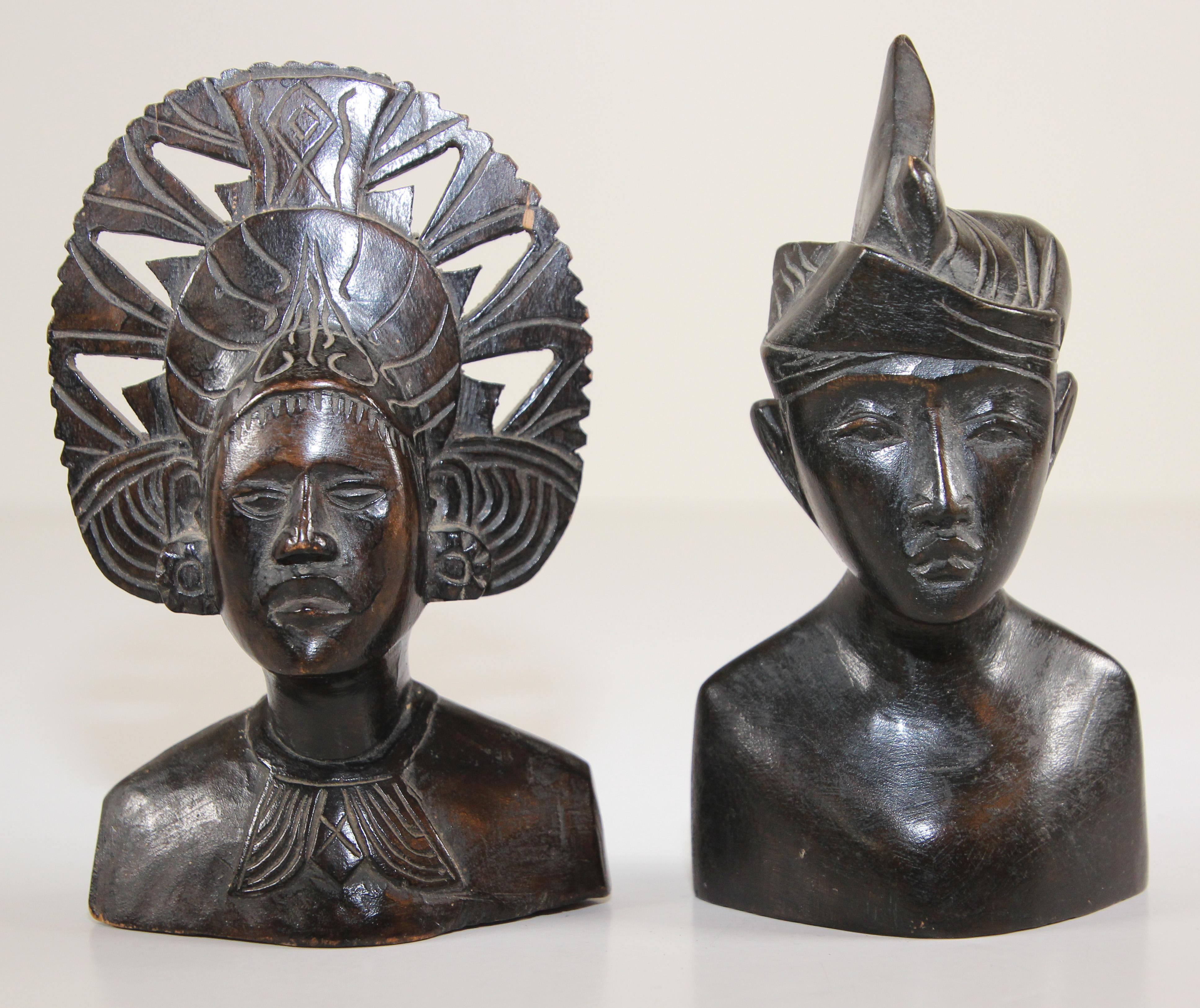 Vintage midcentury hand carved ebony wooden Balinese busts sculptures.
Hand carved sculpture in wood depicting a Balinese couple.
Bust of a man and women in Art Deco style sculpture wearing traditional ceremonial head dress, great