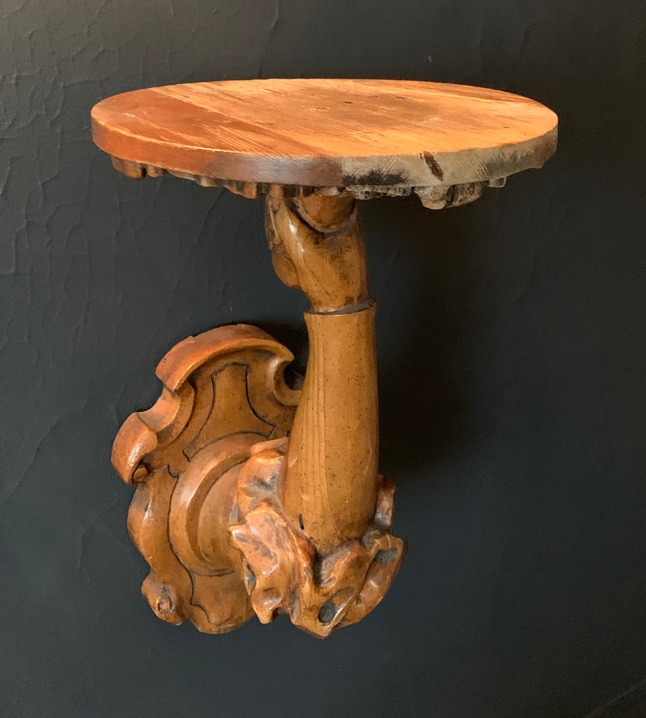 A very special wall shelf bracket - arm to hand, holding a round shelf with bracket. The hand carved piece is uniquely vintage and in good condition, with some wood discoloration but adds to the mystique and charm of this piece. We have placed