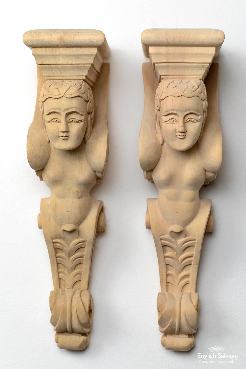 Pair of wooden carved corbels depicting cherubs with their wings folded back along the returns. Simple mouldings at the top and acanthus scroll leaf designs at the bottom. There are a few old fixing holes on the top of the corbels, otherwise they