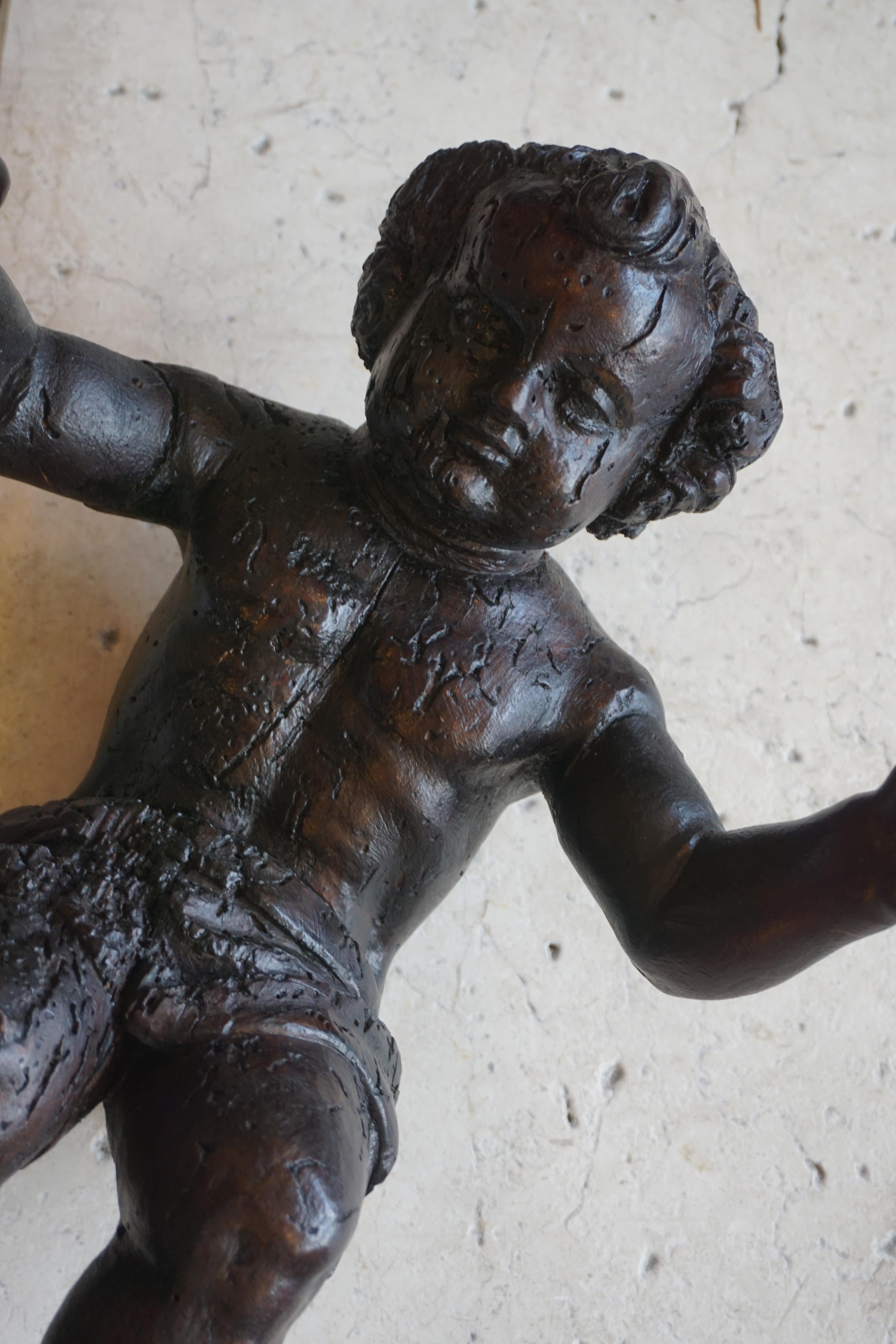 This wooden carving depicts a cherub with open arms, and originates from France, circa 1680.

Measurements: 16'' H x 13'' W x 7'' D.