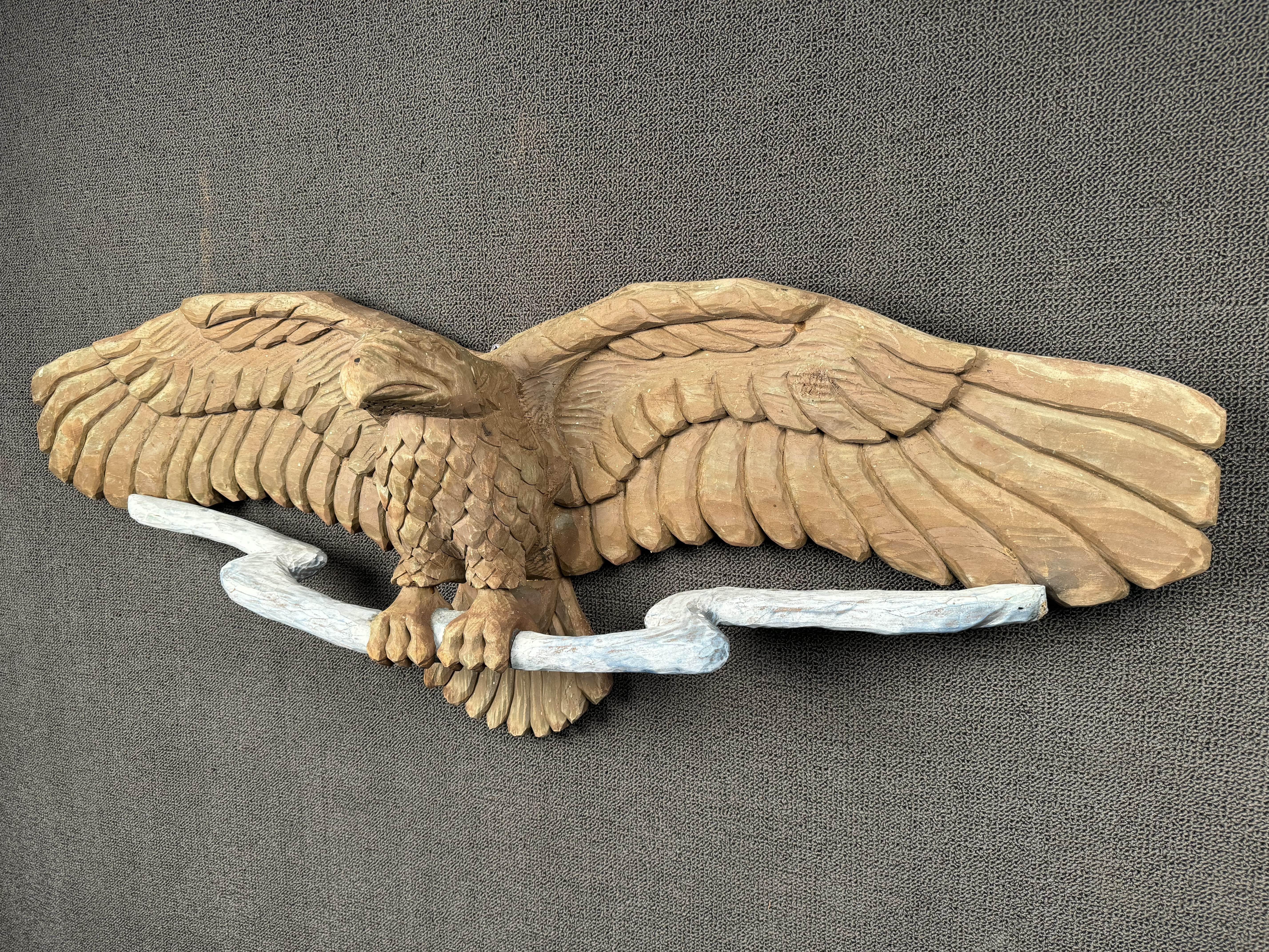 Hand carved wooden eagle on branch. Please confirm location with seller (NY or NJ)