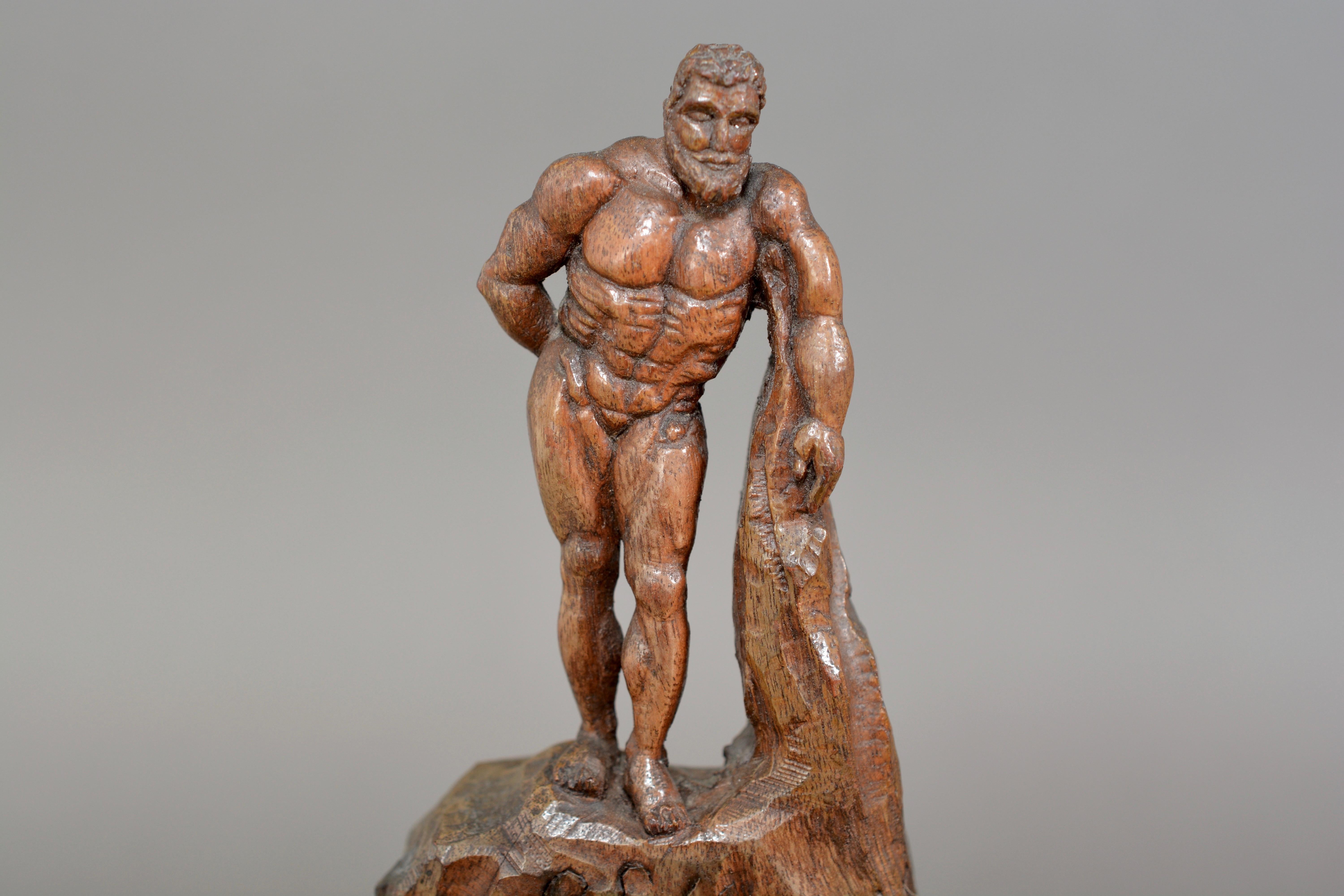 A charming antique wood carving of Hercules. Dating from circa 1900, hand carved from olivewood or fruitwood probably of Italian origin. Very nice original colour and patination. 15.4cms tall and 7.3cms wide.