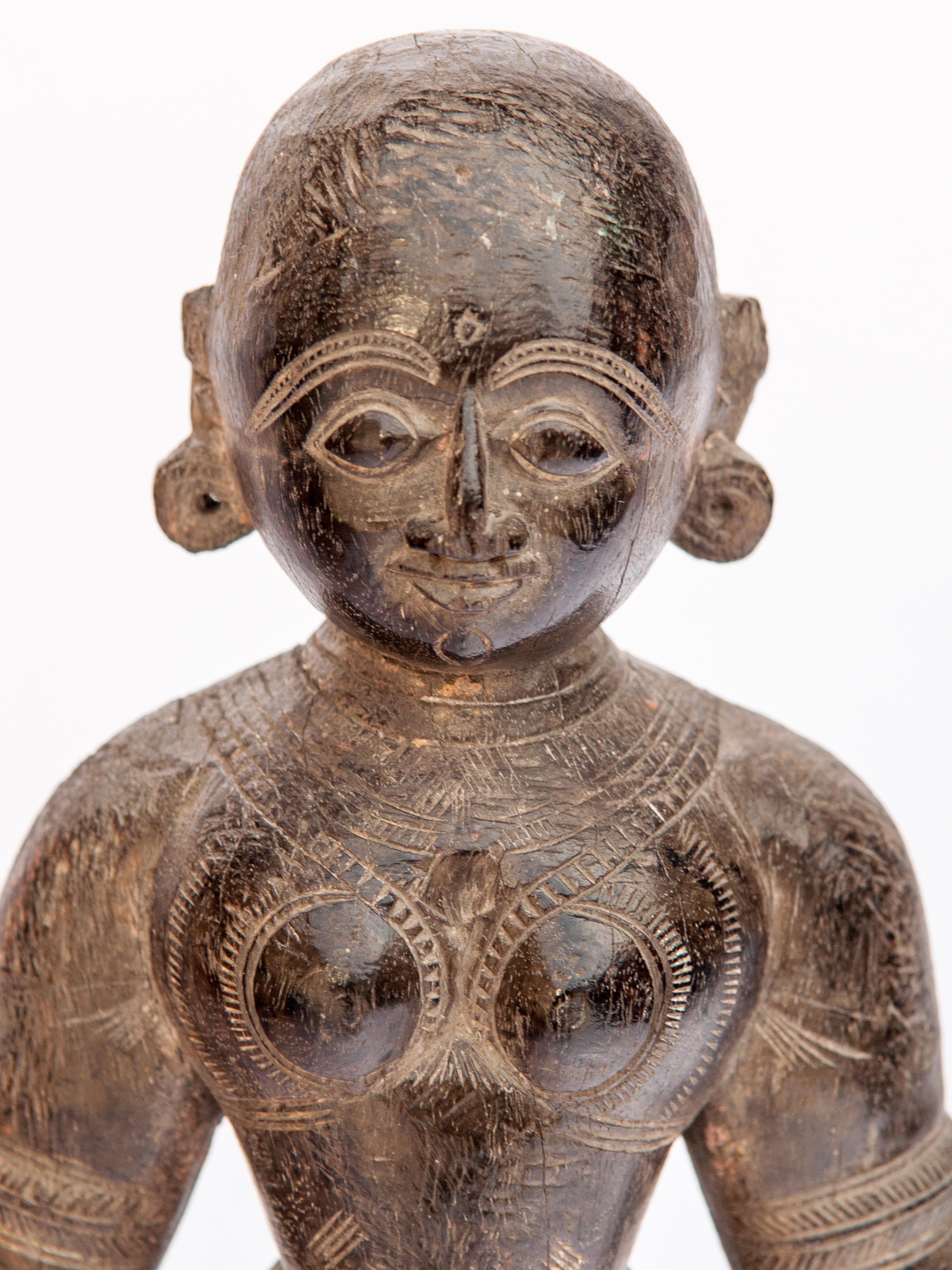 Wood Marapachi doll from Tamil Nadu, mid-20th century, hand-carved of a dense dark wood, mounted on a metal stand.
In the southern Indian state of Tamil Nadu parents present their daughter a pair of dolls, Marapachi Bommai, literally wooden dolls,