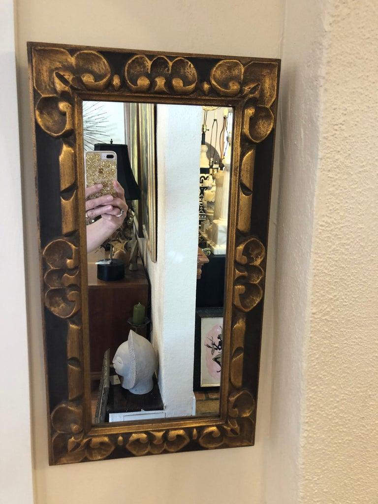 Hand carved gilt wooden mirror. Solid wooden frame. Nice narrow size for that unique space. Gilded accents embellish the carved patterns. This item ships for $45