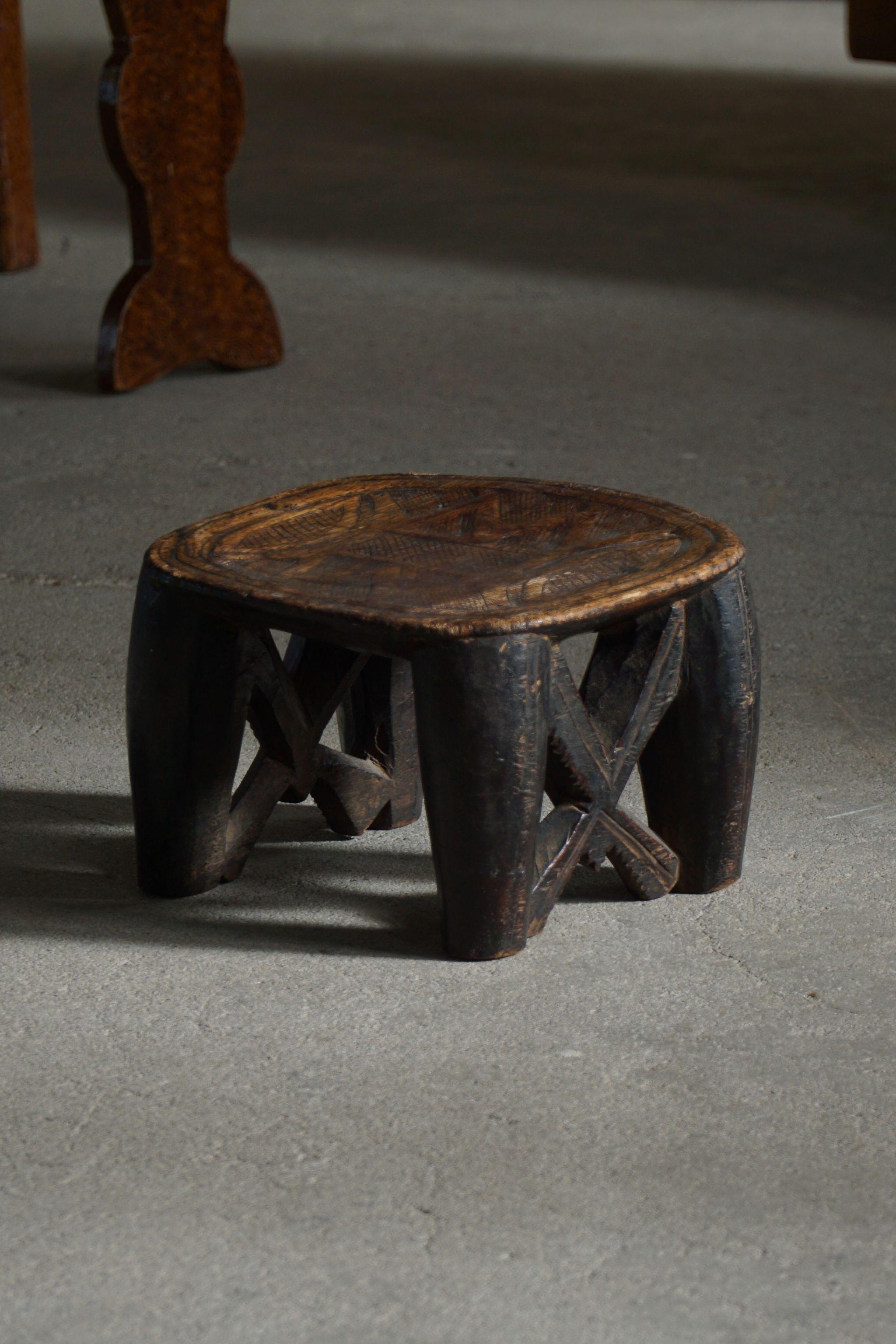 A marvellous hand carved wooden Nupe stool curated by the Nupe people who live alongside the Niger river in Nigeria. The stool would have been used as a prestige item used only for market days or during important meetings. A unique design making it