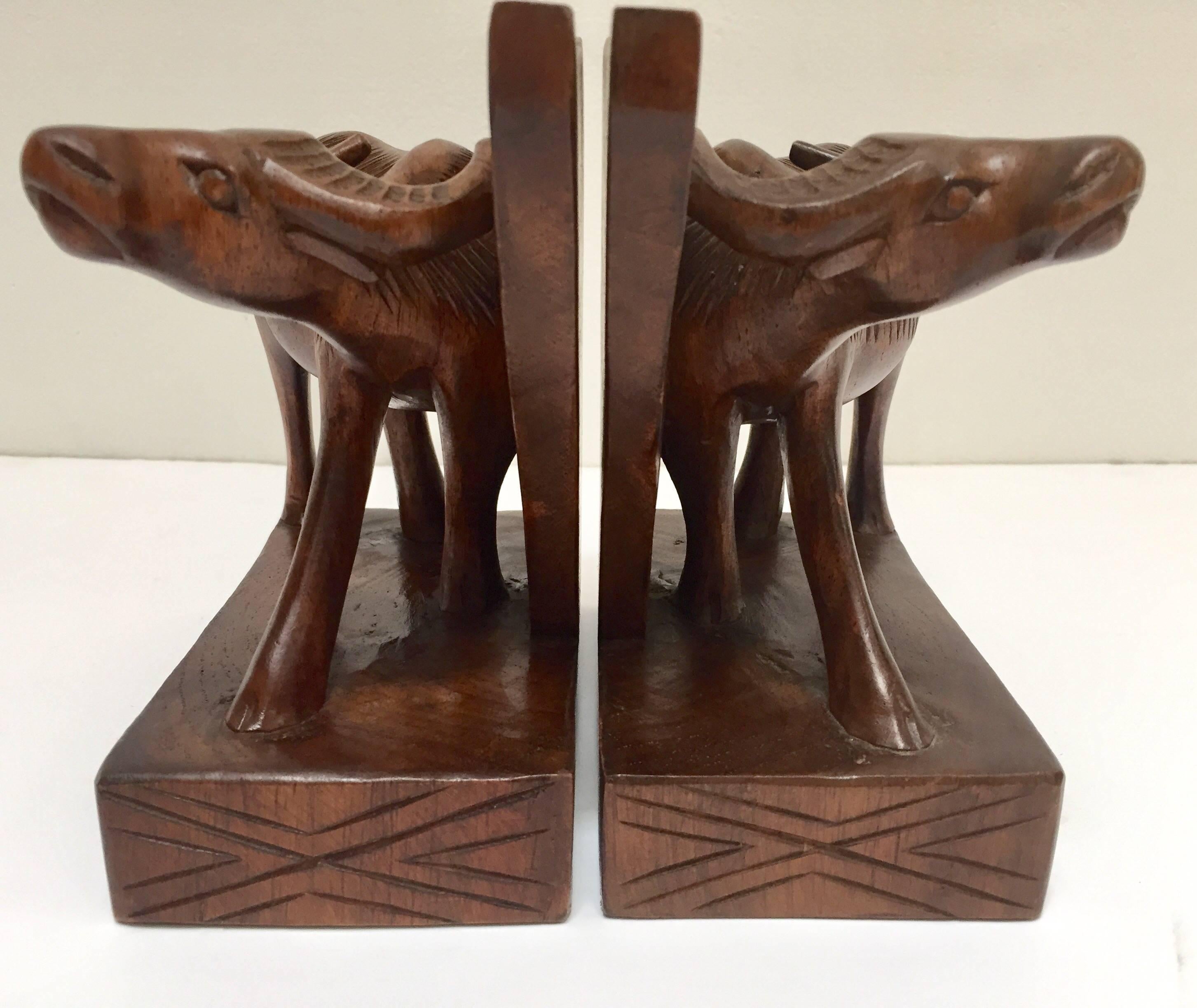 Hand-carved wooden tribal sculptures of African buffalo bookends.
These are hand-carved and therefore not completely identical,
Size for each piece is 7 in H x 6 in W x 3.5 in D.
Tribal African Art