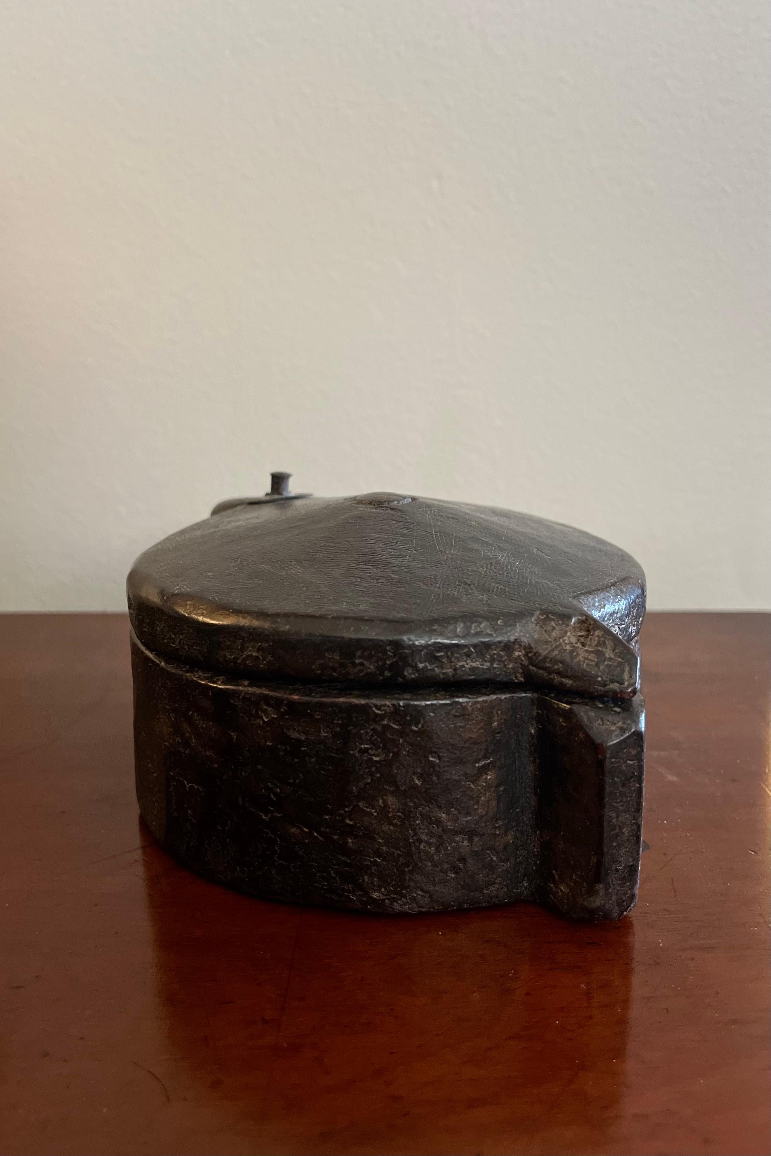 Imported Indian hand-carved wooden spice box with circular body, rotating lid and five interior compartments. A wonderfully hand-worn quality defines the piece's textural presence. Organic and elemental, the box adds an earthy, grounding element to