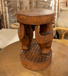Hand-Carved Wooden Stool with Animal Heads