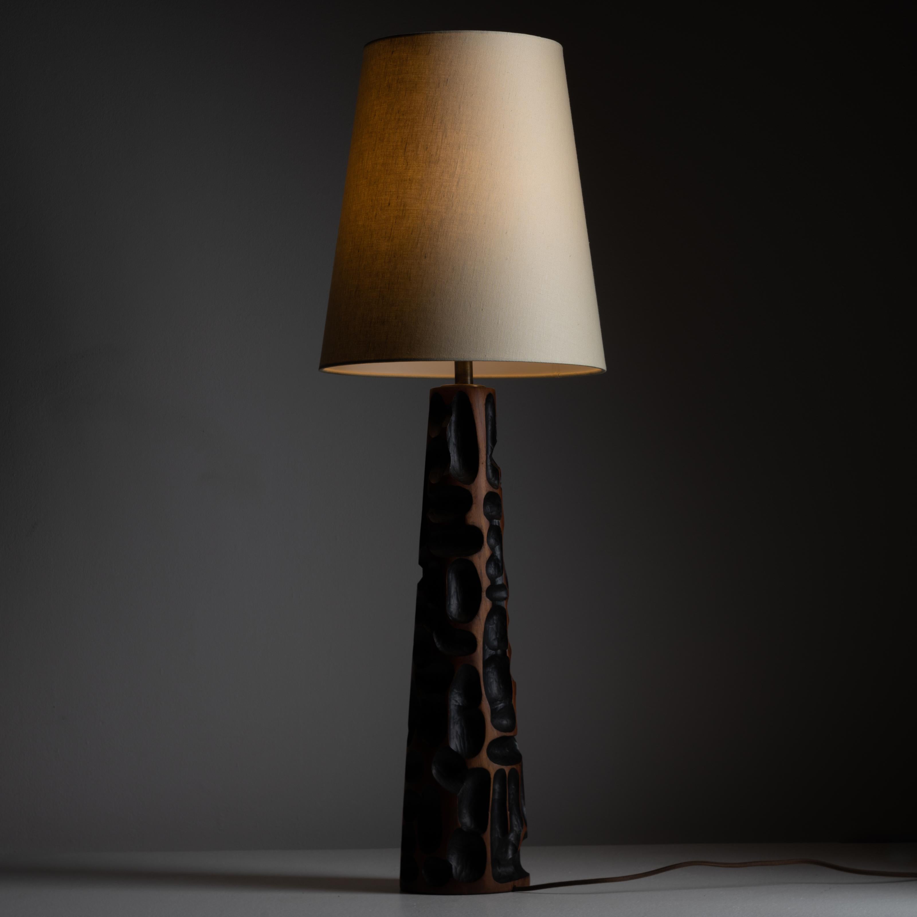 Hand carved wooden table lamp. Designed and manufactured in Italy, circa 1960. Unique hand carved wooden table lamp with blackened carving interiors. We recommend using an E27, 40w maximum bulb. Wired for US Standards. Bulb not included.