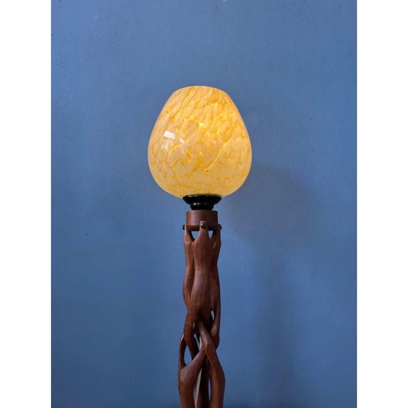 Hand-carved wooden table lamp with glass shade in art deco style. The lamp requires one E14 lightbulb and currently has an EU-plug.

Dimensions:
ø Shade: 13 cm
Height: 43 cm

Condition: Excellent. The base is an excellent shape as well as the glass