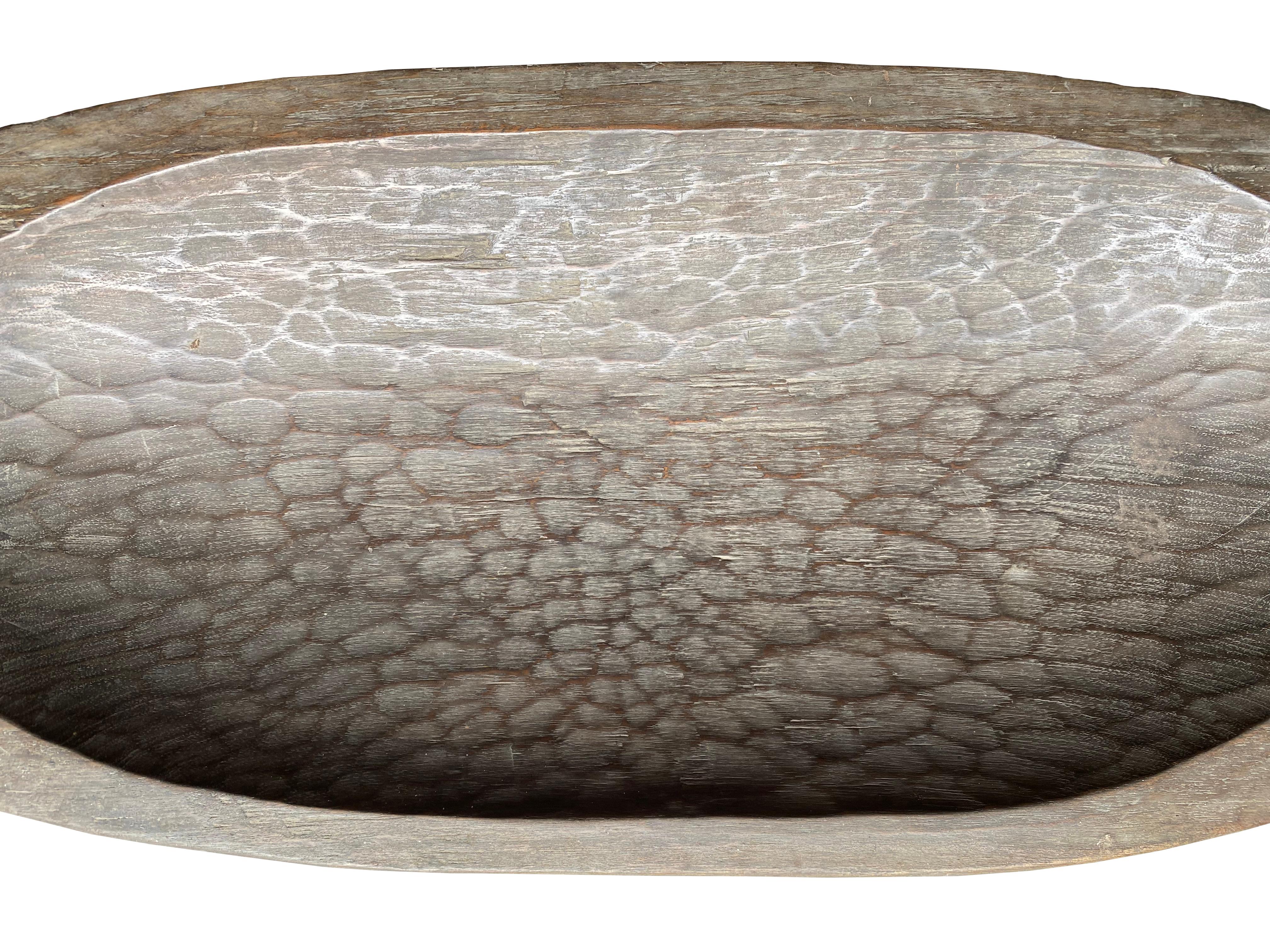 This hand-carved tray comes from the Mentawai tribe found on the Mentawai Islands off the west coast, Sumatra, Indonesia. They are hand-carved from a single block of wood. Sought after for their beautiful hand-carved textures and shallow elongated
