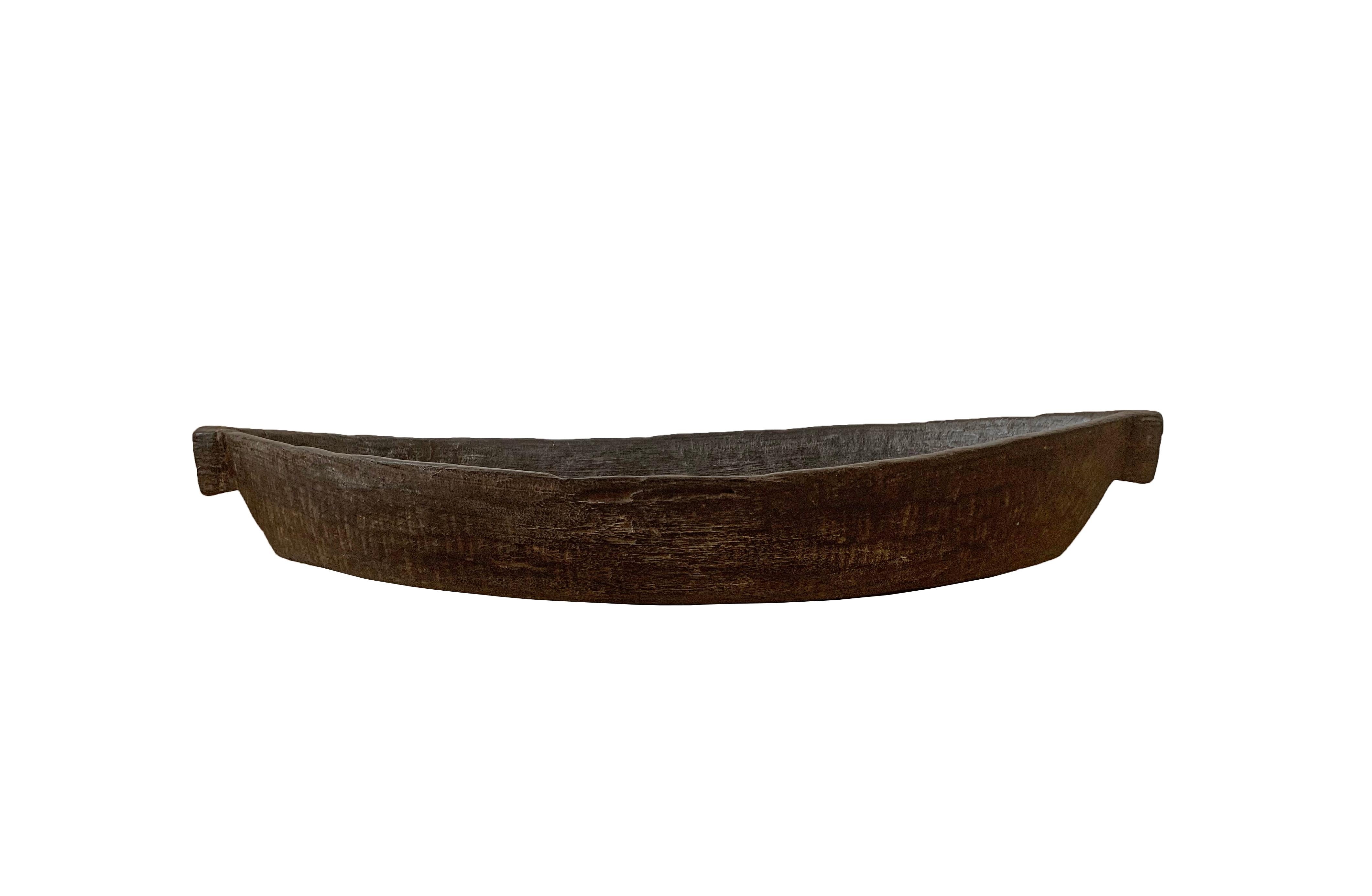 Dieses handgeschnitzte Tablett stammt vom Stamm der Mentawai, der auf den Mentawai-Inseln vor der Westküste Sumatras, Indonesien, lebt. Er wird von Hand aus einem einzigen Holzblock geschnitzt. Diese Tabletts sind wegen ihrer schönen länglichen Form
