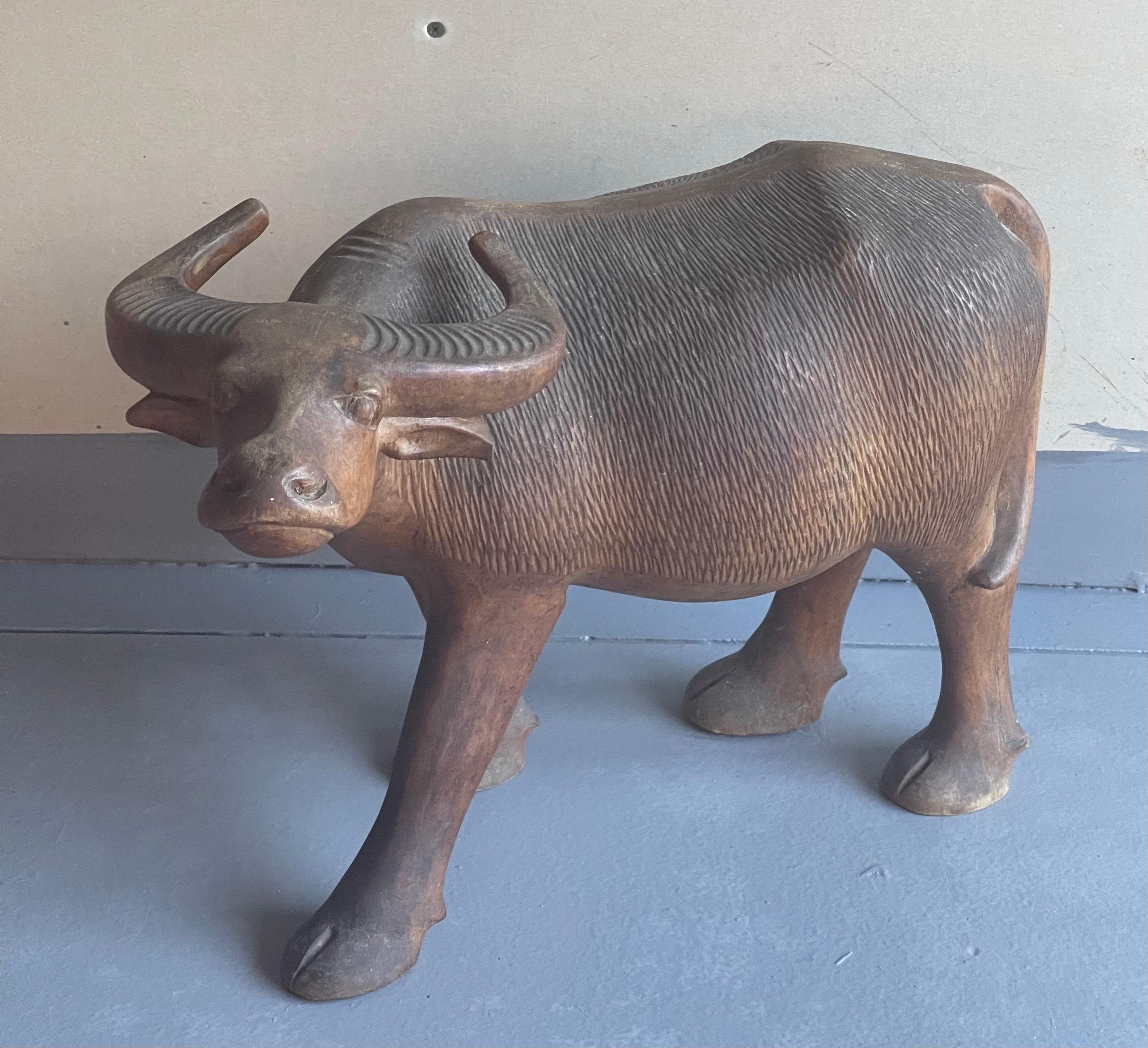 A very cool hand carved wooden water buffalo sculpture, circa 1970s. The piece is in very good vintage condition with wonderful detail and measures an impressive 17