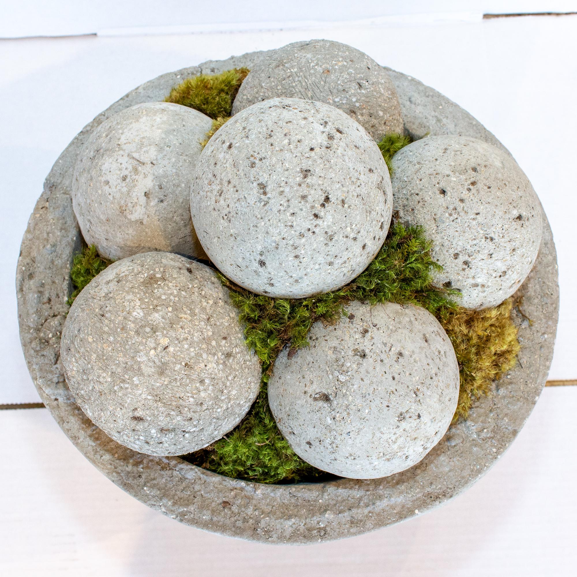 This stone centerpiece is actually made up of two separate pieces, the square base is cast stone and the bowl on top is cast hypertufa, which is an expanded stone that is slightly lighter than concrete. The bowl has been piled high with hypertufa