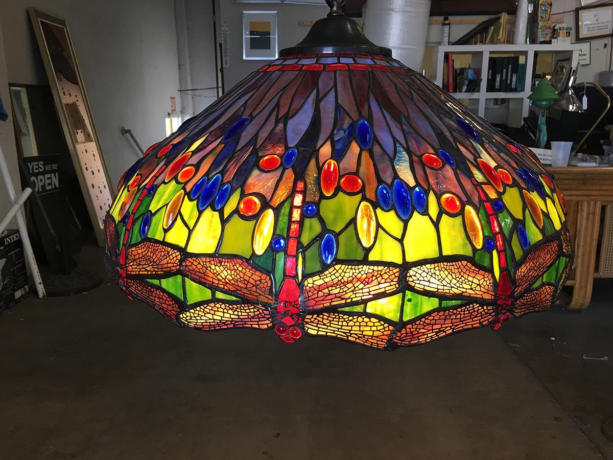 Hand casted Tiffany-style stained glass hanging dragonfly chandelier.

This lamp is handcrafted in the USA with the highest quality materials and over 30 years of experience in Luxury: Lighting (chandeliers, floor lamps, table lamps, sconces),