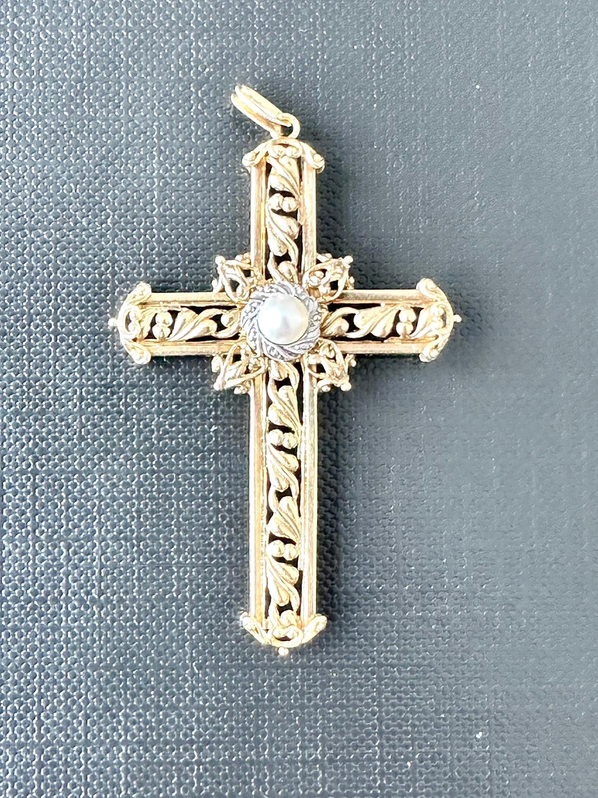 Gorgeous Italian Cross in 18kt Yellow and White Gold. The Pearl is set on a white gold crown in the center of the pendant. This cross is special due to the different techniques used to work the gold. Appliqué, open work, granulation. 
Appliqués are