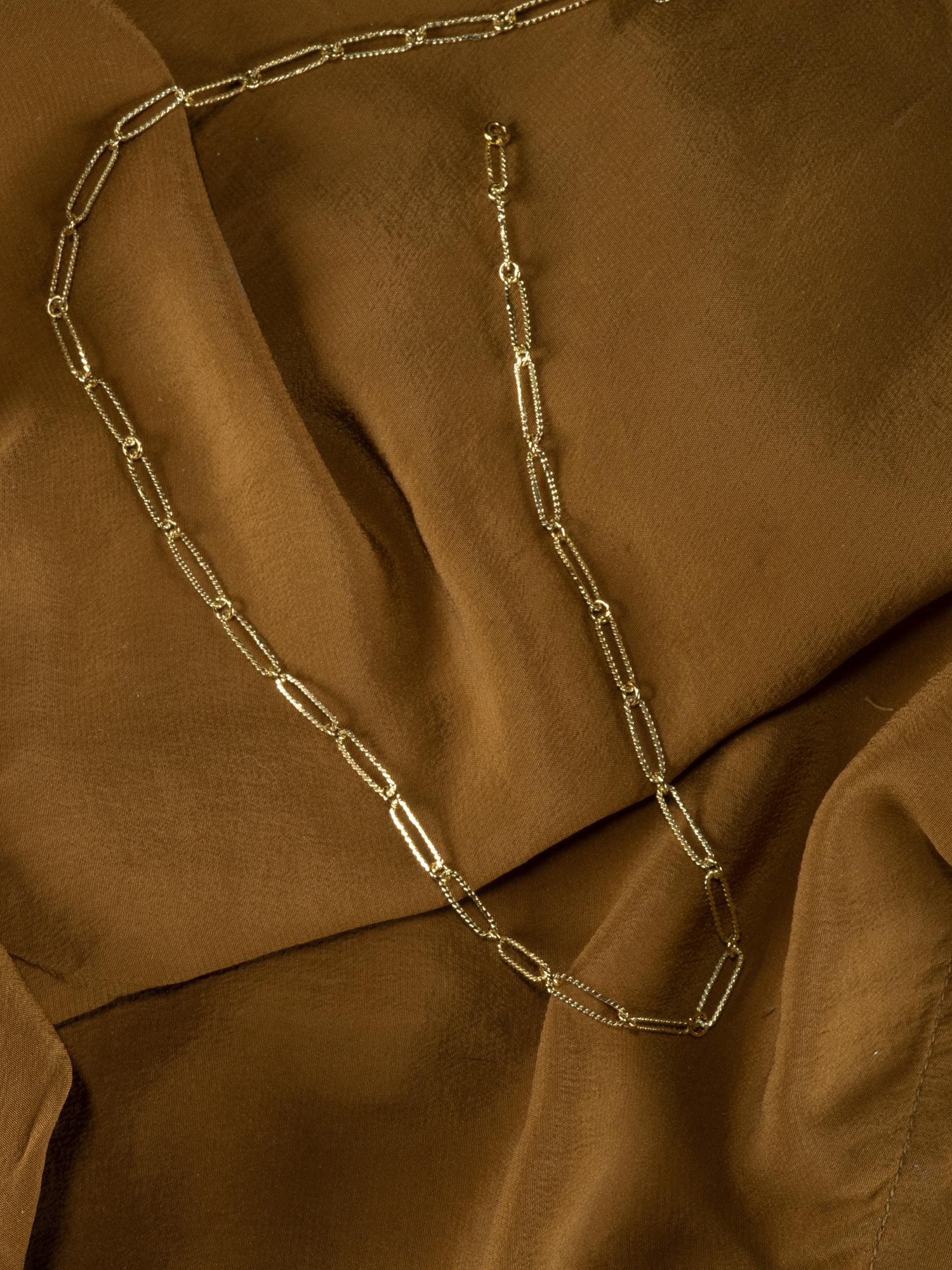 Part of our signature chain collection, the Olivia Necklace resembles the modern paperclip chain but with a twist. Literally. Crafted entirely by hand, our links are made in the traditional filigree method where gold wires are twisted together to