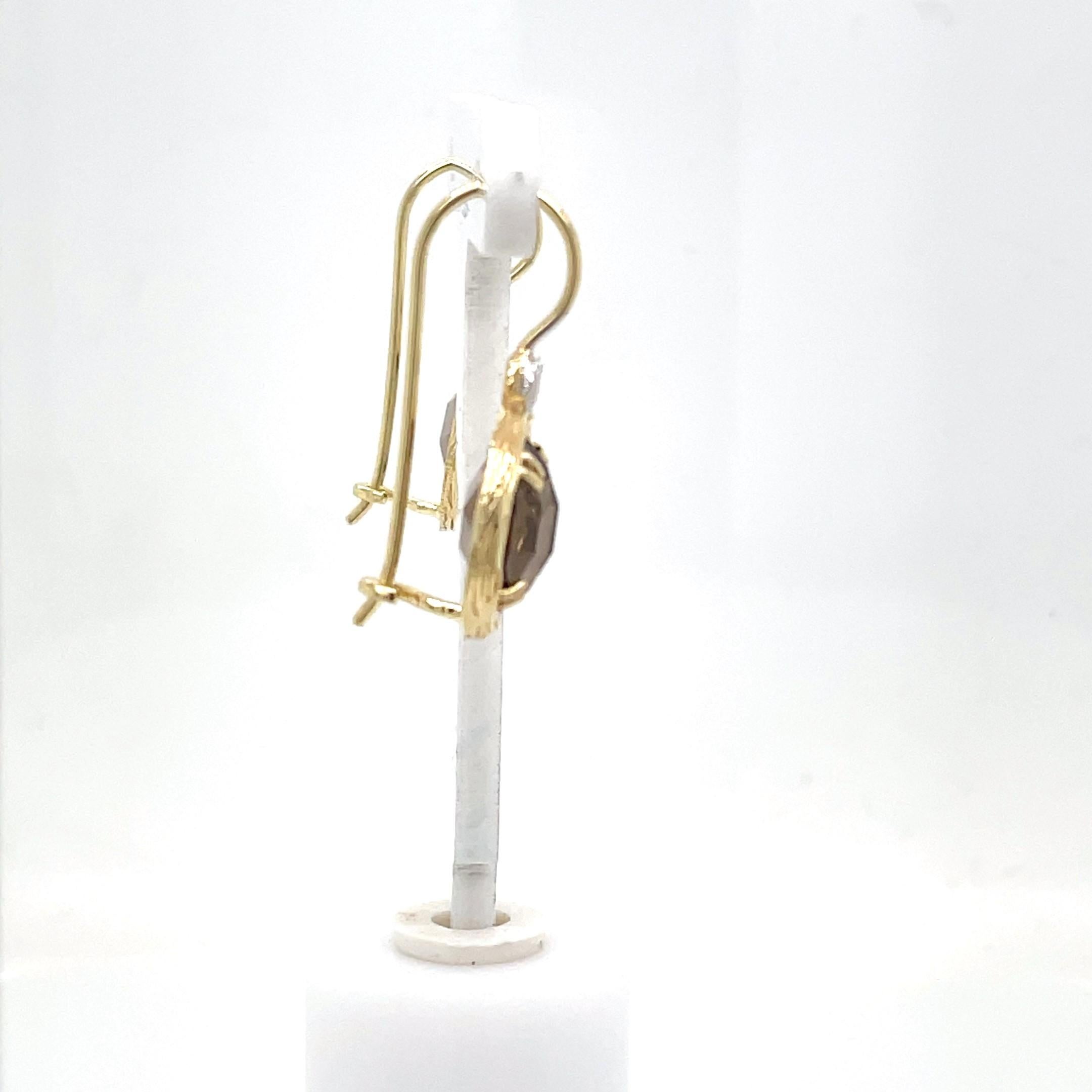 14 Karat Yellow Gold Hand-Crafted Polish-Finished Drop Earrings, Set with 7.0ct 10mm Round Checkerboard Smokey Topaz Semi-Precious Color Stones, and Accented with 0.03 Carats of Bezel Set Diamonds.
