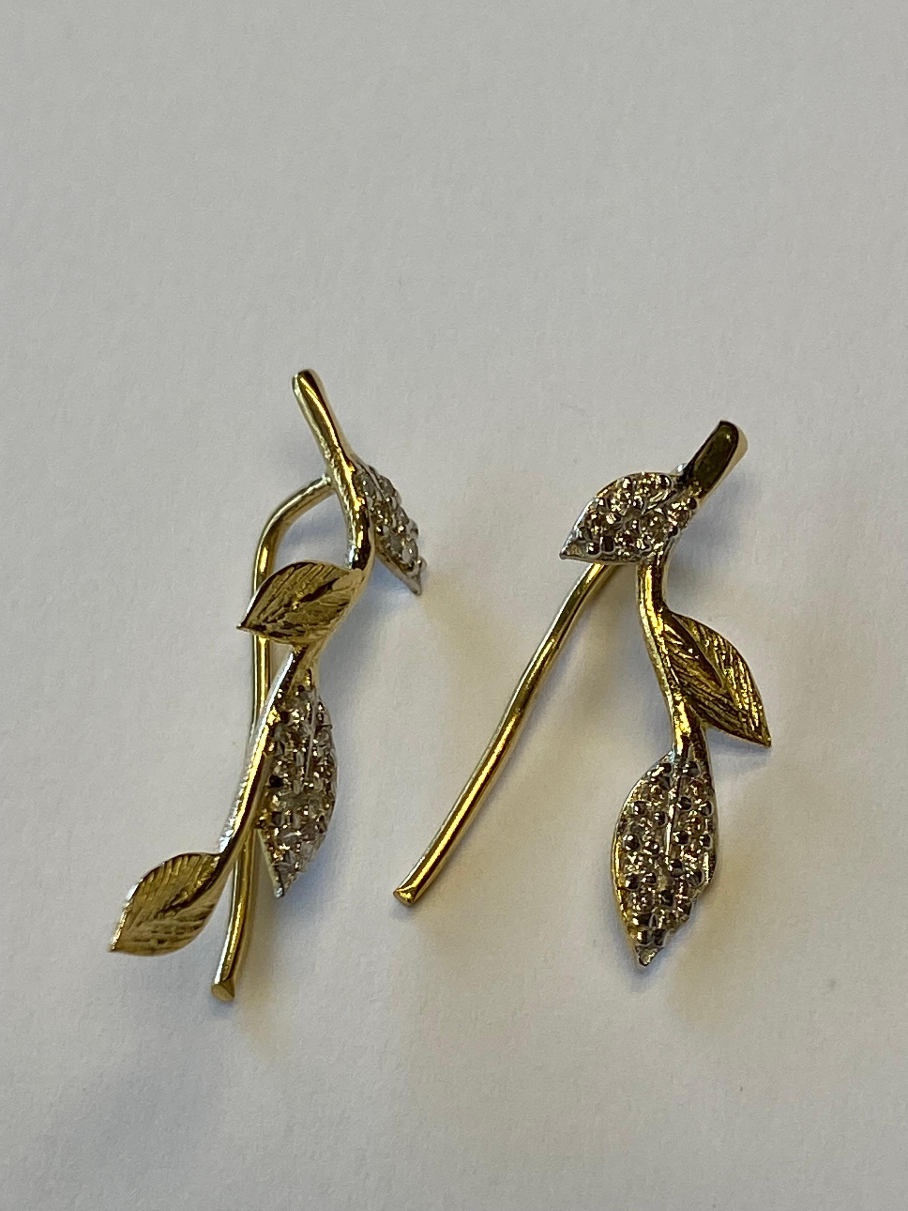 14 Karat Yellow Gold Hand-Crafted Polish-Finished Hand-Crafted Leaf Vine Climber Earrings, Accented with 0.18 Carats of Pave Set Diamond Leaves.  Wire Back Finding Closure.
