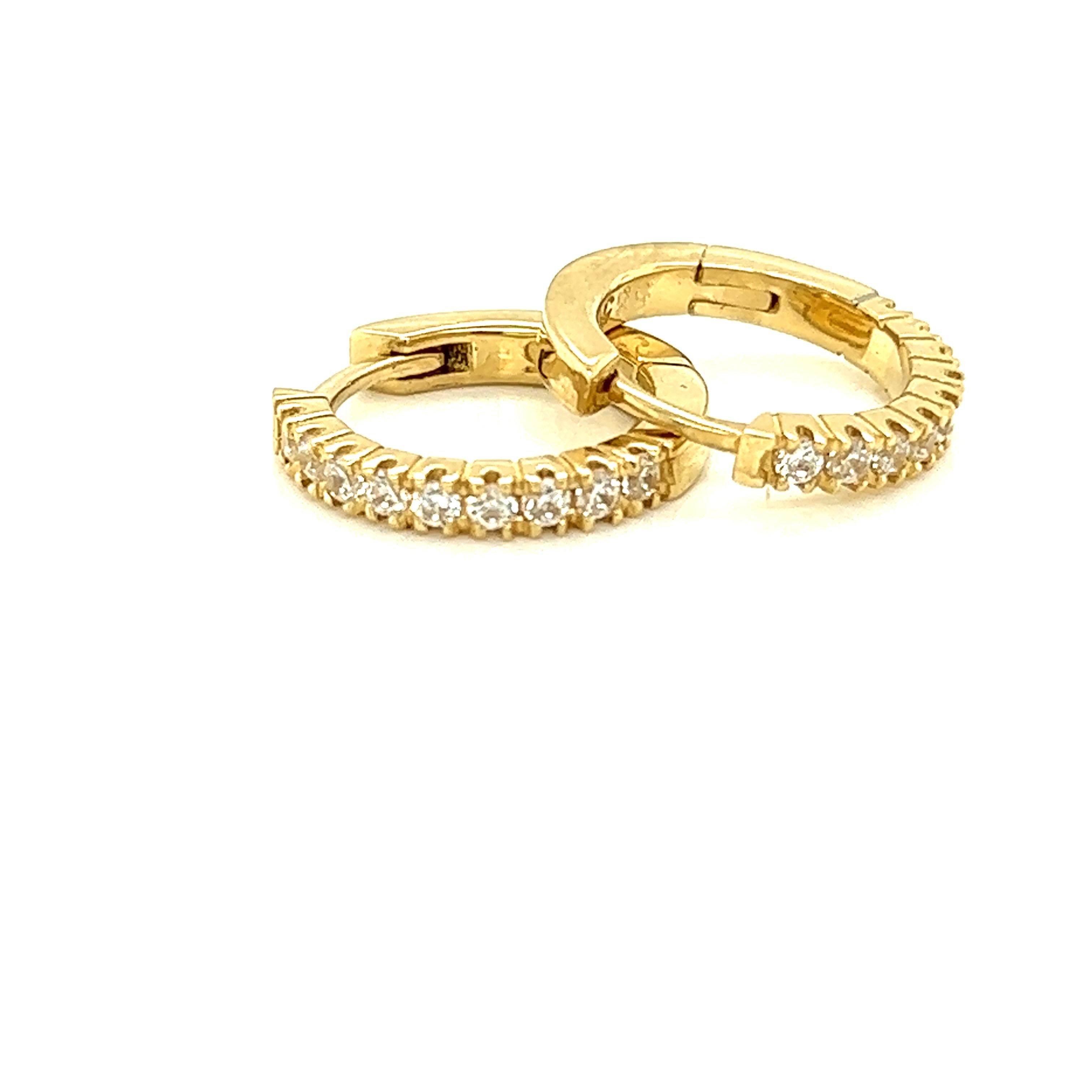 14 Karat Yellow Gold Hand-Crafted Polish-Finished 15mm Diamond Hoop Earrings, Set with 0.50 Carat Diamonds and a Hinge-Back Closure.
