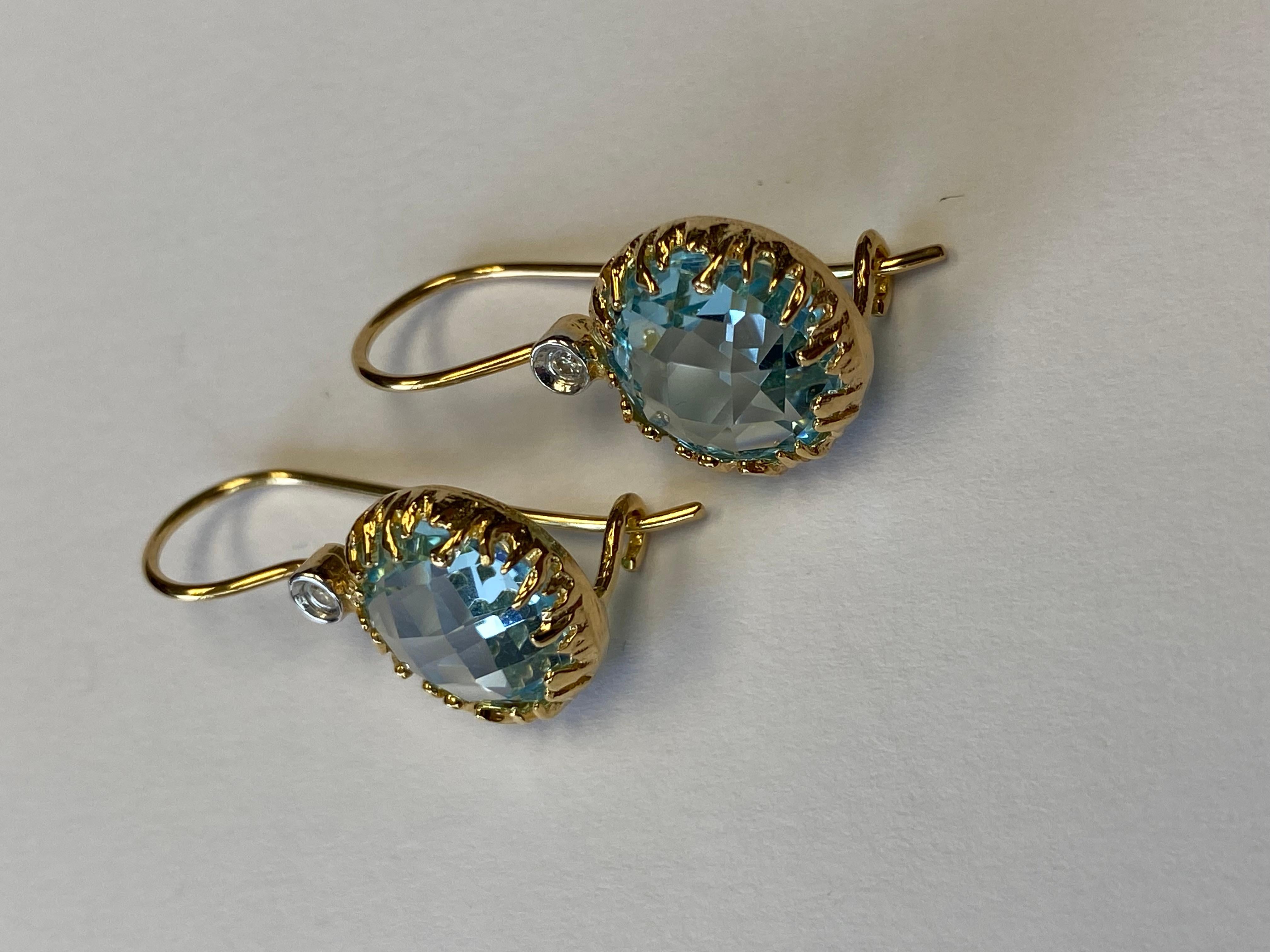 14 Karat Yellow Gold Hand-Crafted Polish-Finished Drop Earrings, Centered with a 10mm 8.5CT Round Checkerboard-Cut Semi-Precious Blue Topaz Color Stone, Accented with 0.03 Carats of Bezel Set Diamonds on a Kidney Wire Back Finding
