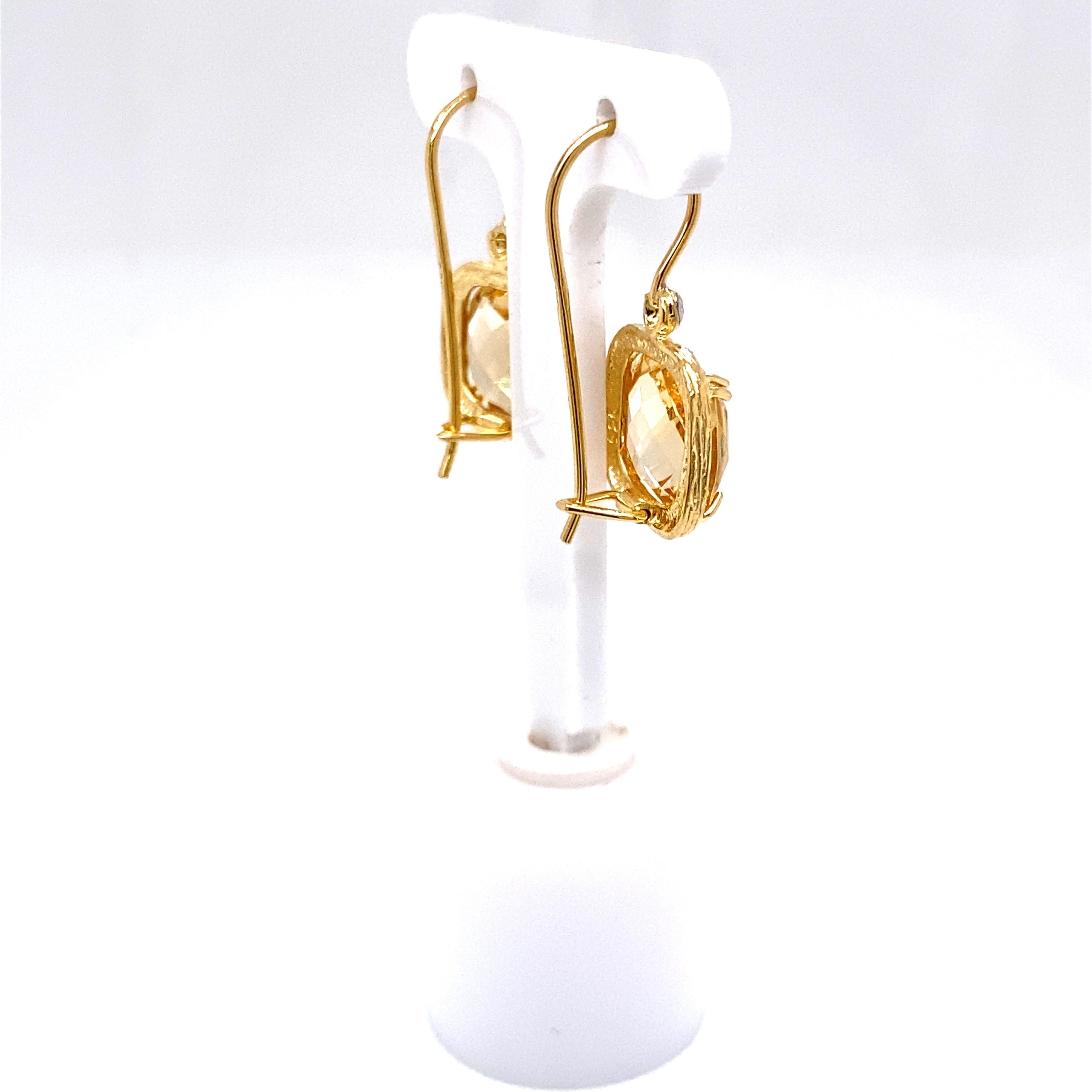 14 Karat Yellow Gold Hand-Crafted Polish-Finished Drop Earrings, Set with a 10mm Cushion-Cut Semi-Precious Citrine Color Stone, and Accented with 0.04 Carats of Bezel Set Diamonds.
