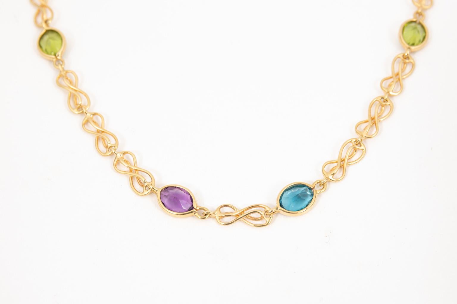 Lovely hand crafted necklace. There are 18 bezel set Amethyst, Peridot and Blue Topaz each about 6 X 8 mm or 1 carat. The gemstones are linked with hand crafted twisted links, and finished with a lobster claw clasp. The necklace is very heavy at