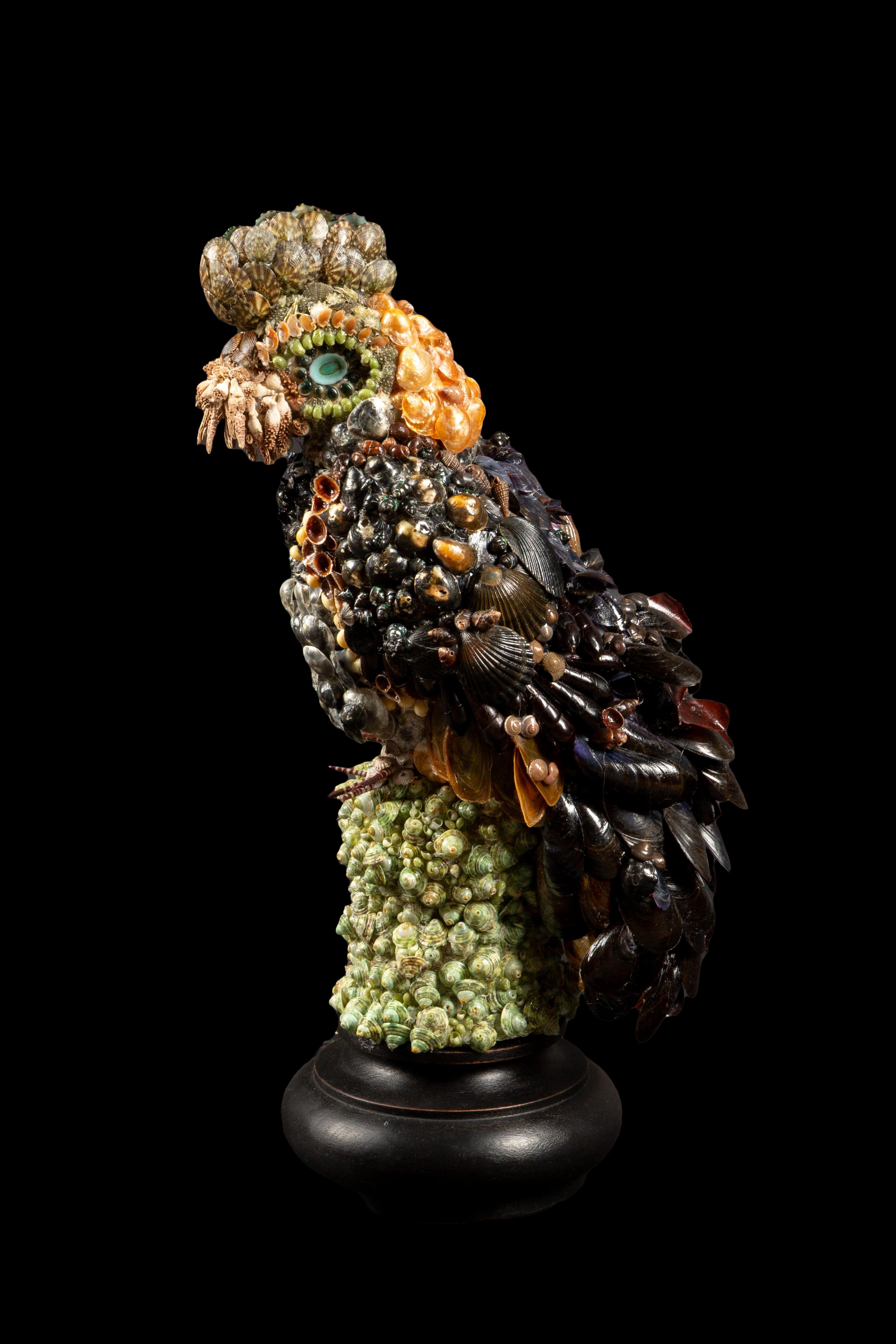 Meticulously crafted, hand-made Mixed Shell Mosaic Parrot, standing tall at an impressive 17.5 inches in height. This exquisite piece combines a harmonious blend of various shells, expertly arranged to capture the intricate beauty of a parrot in